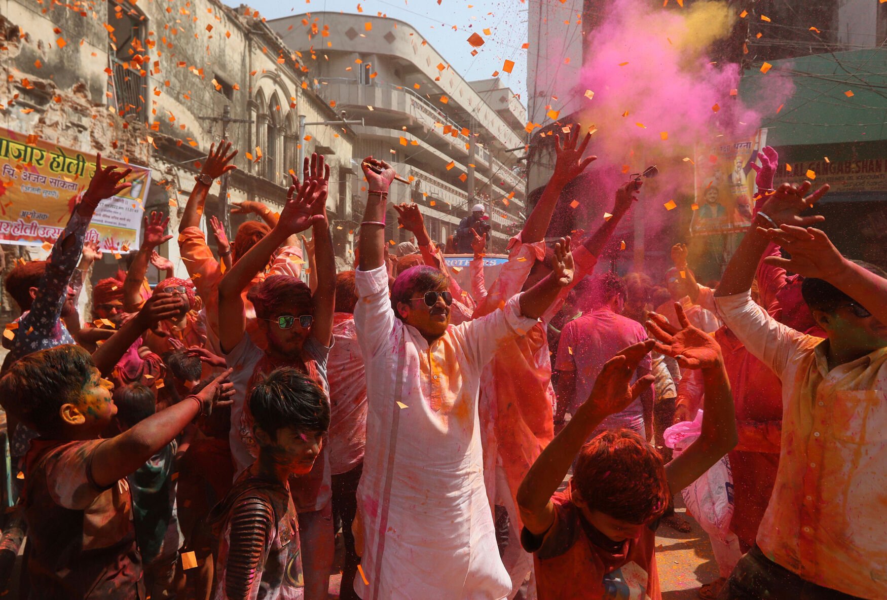 <p>A crowd in Hyderabad, India, throws colored powders into the air during a Holi celebration.</p>