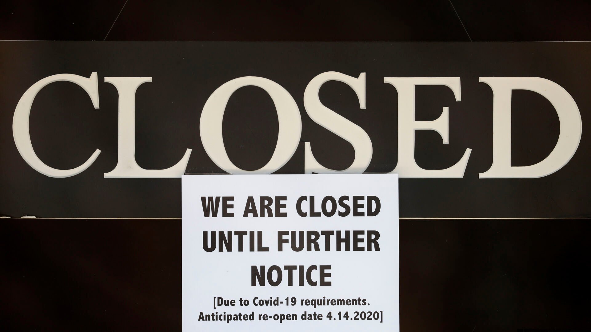 <p>In this April 2, 2020 file photo, a notice of closure is posted at The Great Frame Up in Grosse Pointe Woods, Mich. </p>