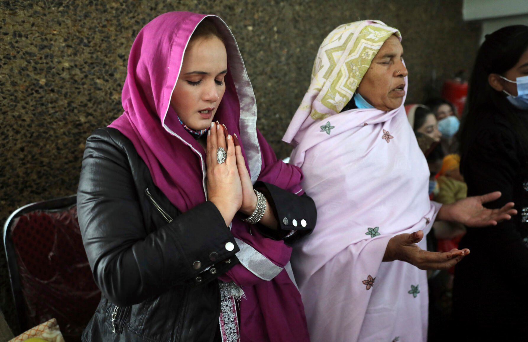 <p>Christian women pray during a Christmas Mass in Our Lady of Fatima Church in Islamabad, Pakistan, Saturday, Dec. 25, 2021. (AP Photo/Rahmat Gul)</p>