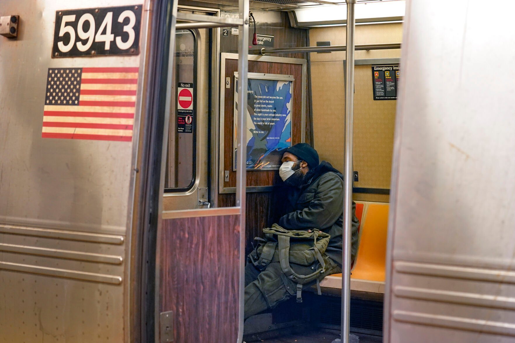 <p>FILE - A man sleeps in a subway car in New York on Feb. 21, 2022. </p>