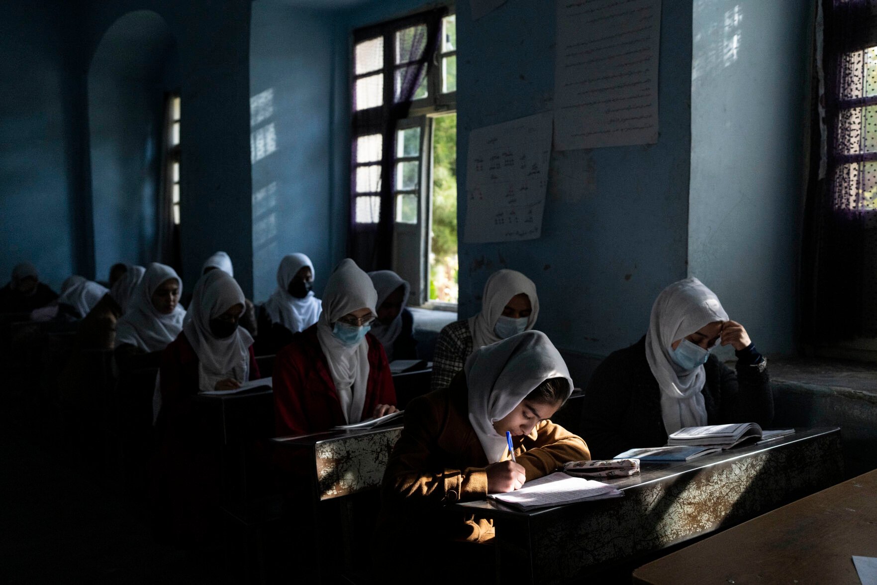 <p>FILE - Afghan girls participate in a lesson at Tajrobawai Girls High School in Herat, Afghanistan on Nov. 25, 2021. In a surprise decision the hardline leadership of Afghanistan's new rulers has decided against opening educational institutions to girls beyond Grade six, a Taliban official said Wednesday, March 23, 2022 on the first day of Afghanistan's new school year. (AP Photo/Petros Giannakouris, File)</p>