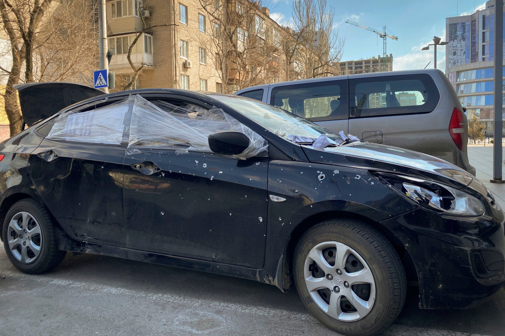 <p>A car damaged by shelling that was used by Associated Press journalists to escape from the Mariupol blockade sits parked in Ukraine, Thursday, March 17, 2022. </p>