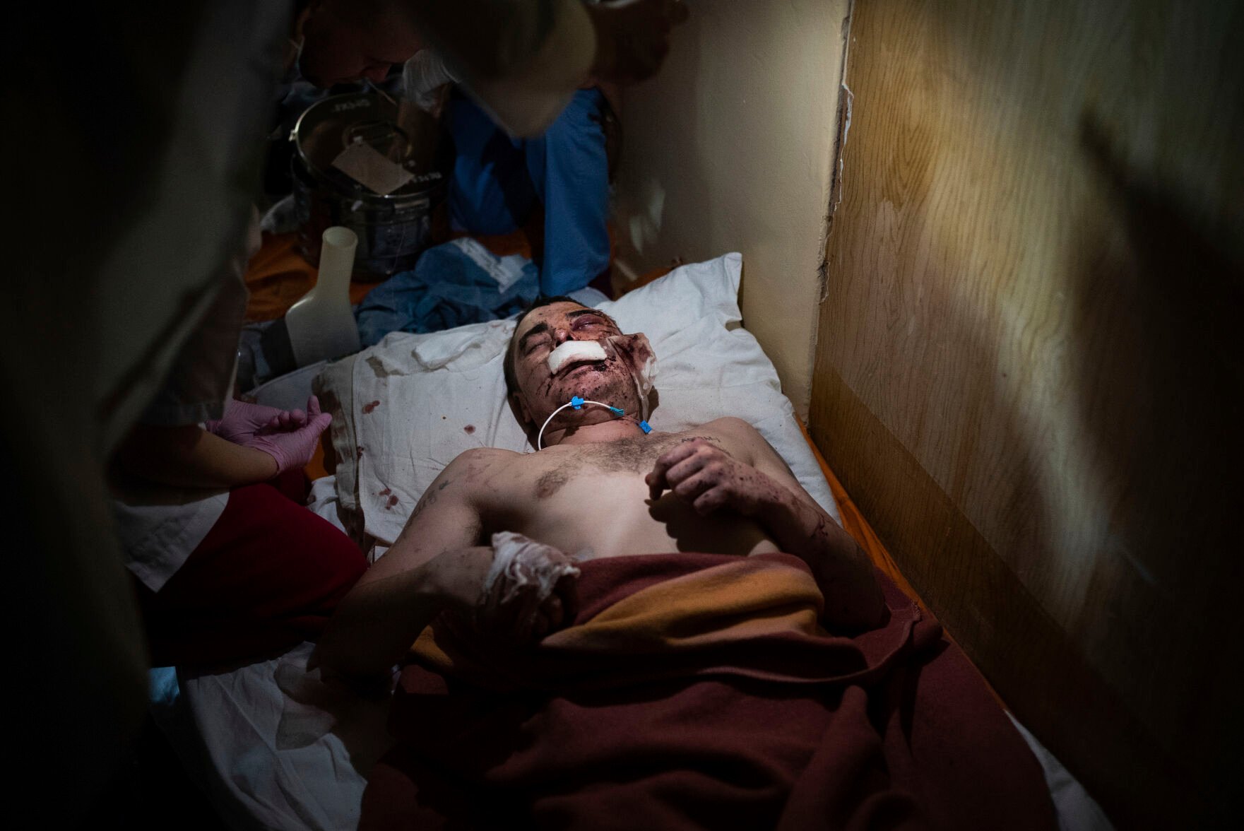 <p>Medical workers treat a man, wounded by shelling, in a hospital in Mariupol, Ukraine, Friday, March 4, 2022. </p>