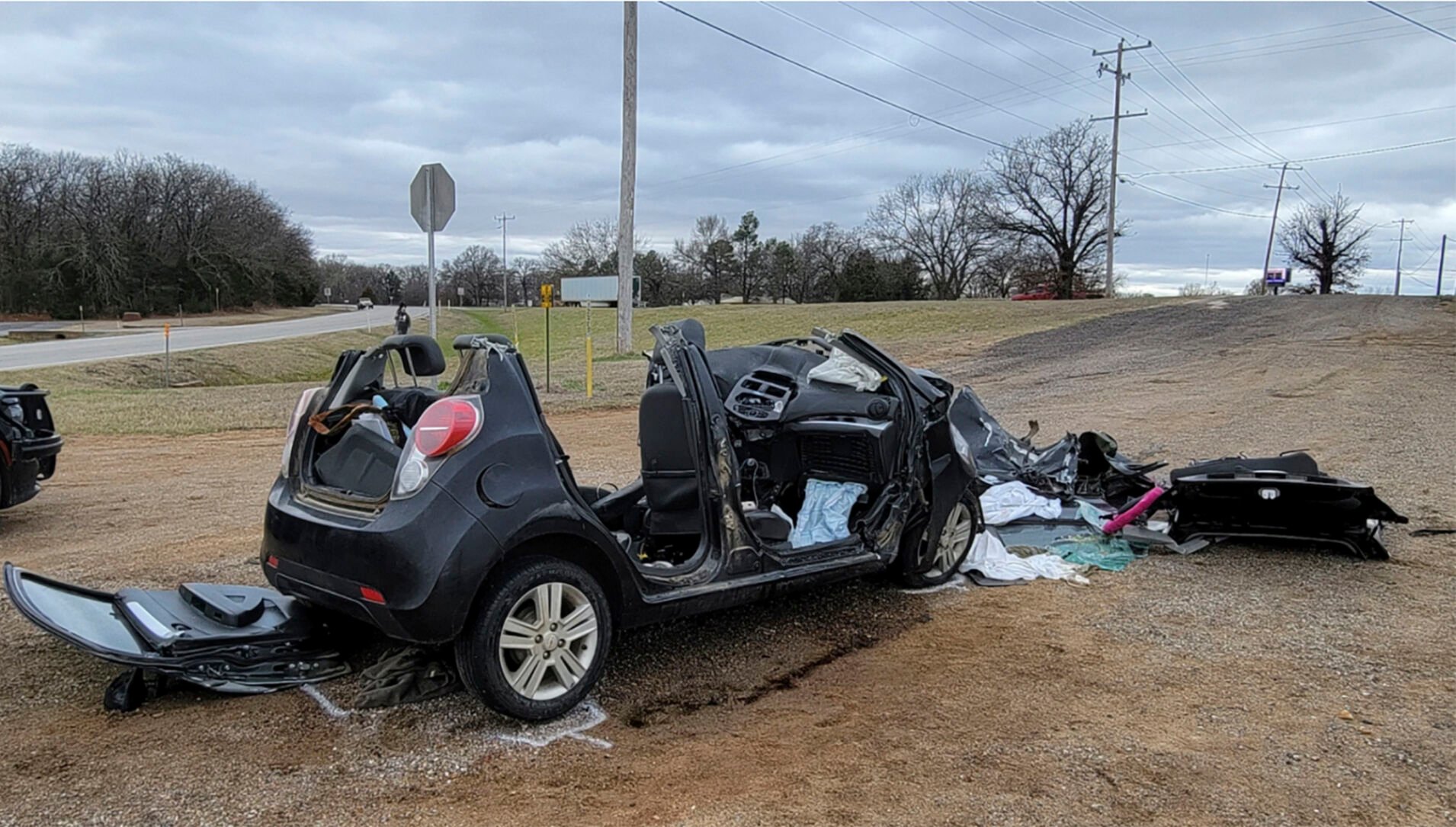 <p>In this image provided by KFOR-TV, a heavily damaged vehicle is seen off a road in Tishomingo, Okla., following a two-vehicle collision in which six teenage students were killed, Tuesday, March 22, 2022. </p>