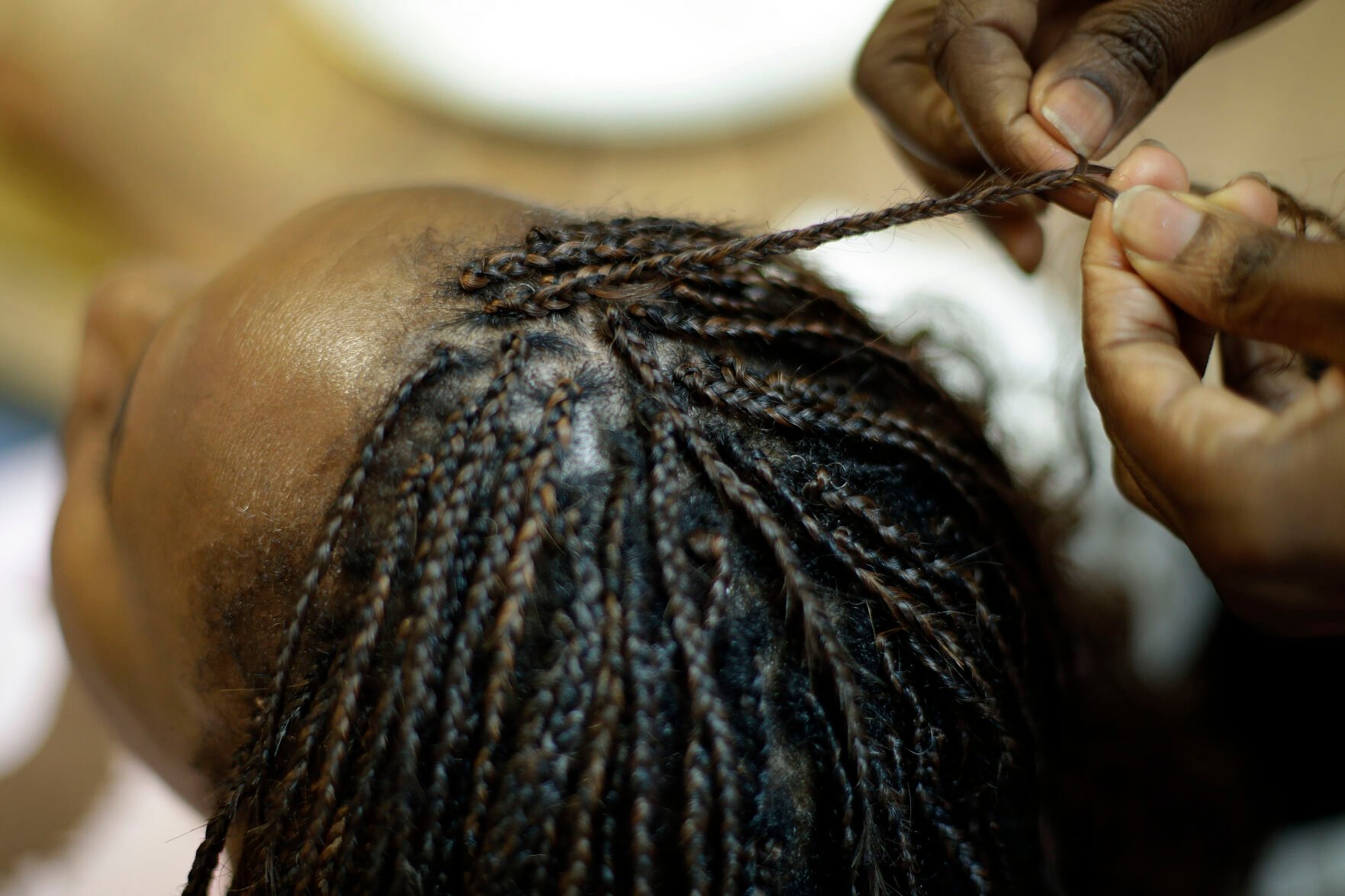 <p>Shelly Smith braids hair at her salon, Braid Heaven, Jan. 28, 2020, in Kansas City, Kan.</p>