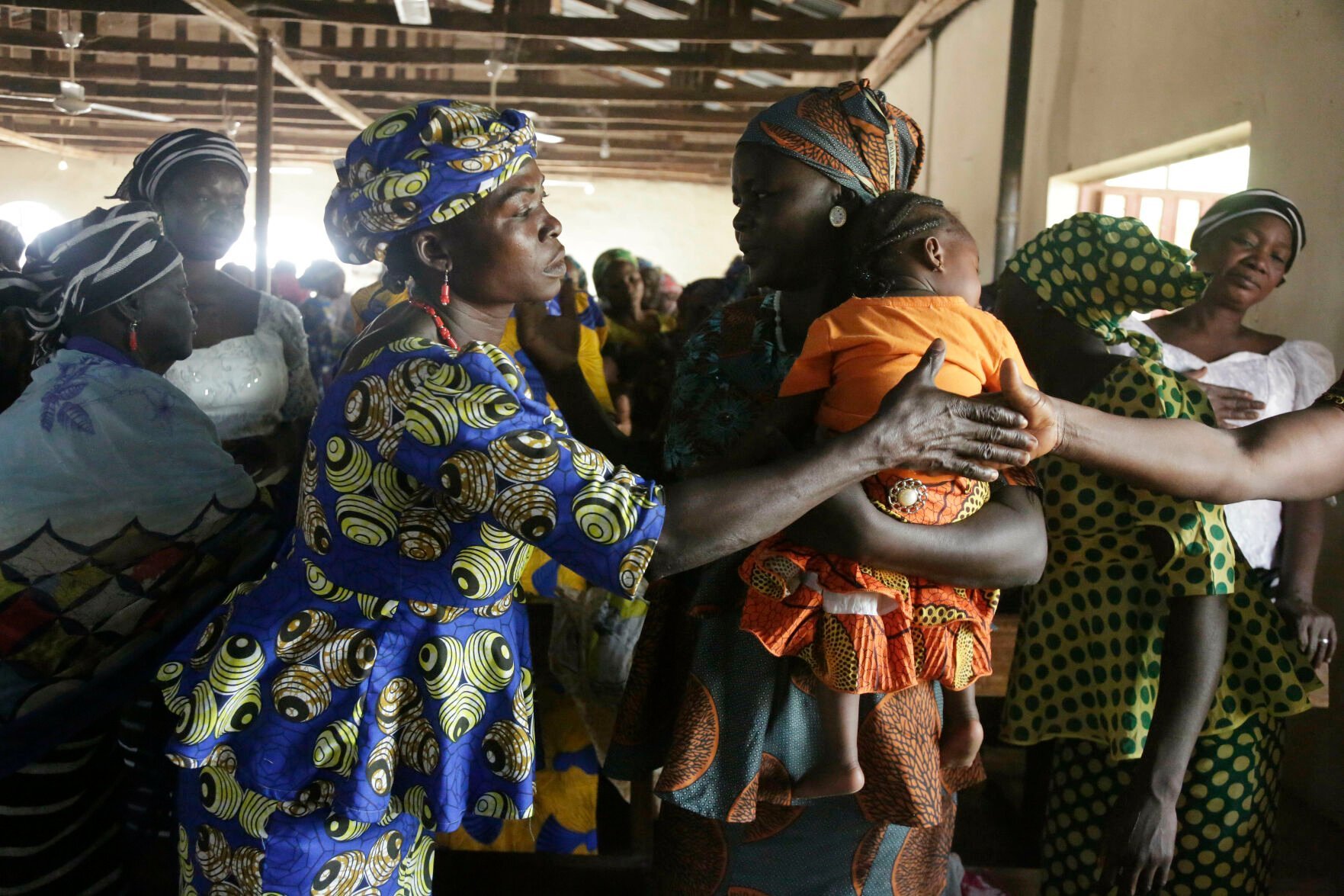 <p>Nigerian women greet each other at St Charles Catholic Church, during a mass in Ngurore , Nigeria, Sunday, Feb. 17, 2019. (AP Photo/ Sunday Alamba)</p>