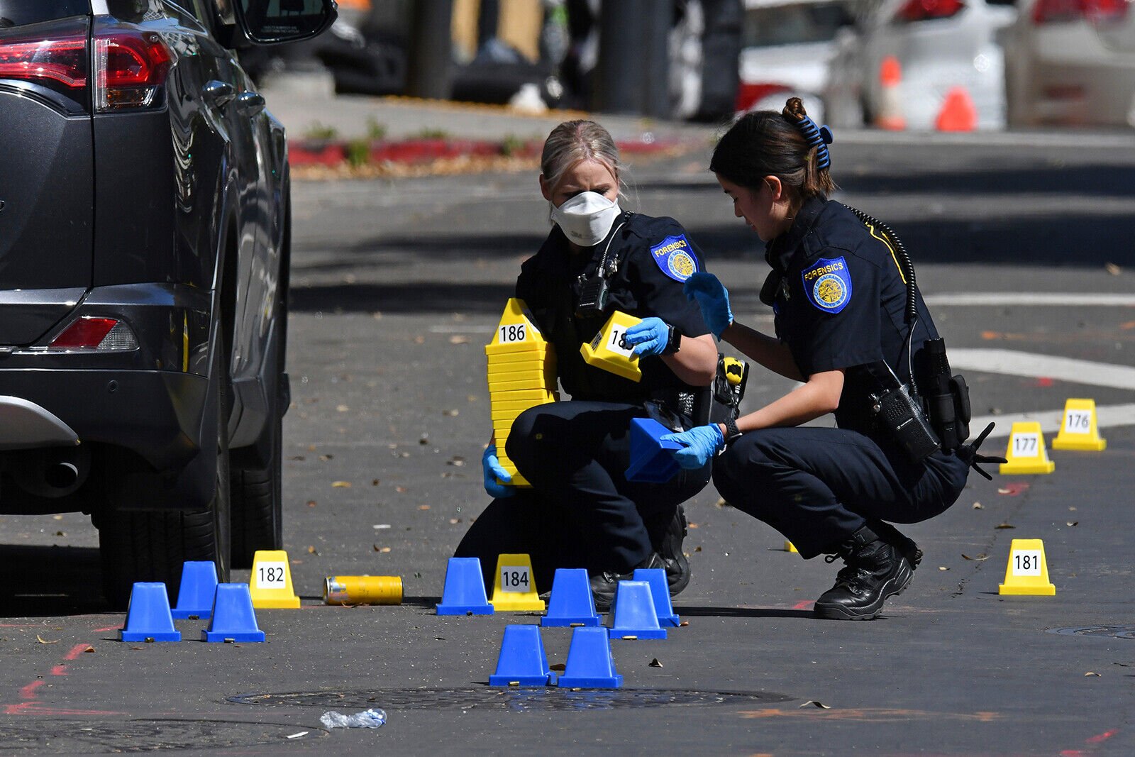 <p>Sacramento Police crime scene investigators place evidence markers on 10th street at the scene of a mass shooting in Sacramento, Calif., on Sunday, April 3.</p>