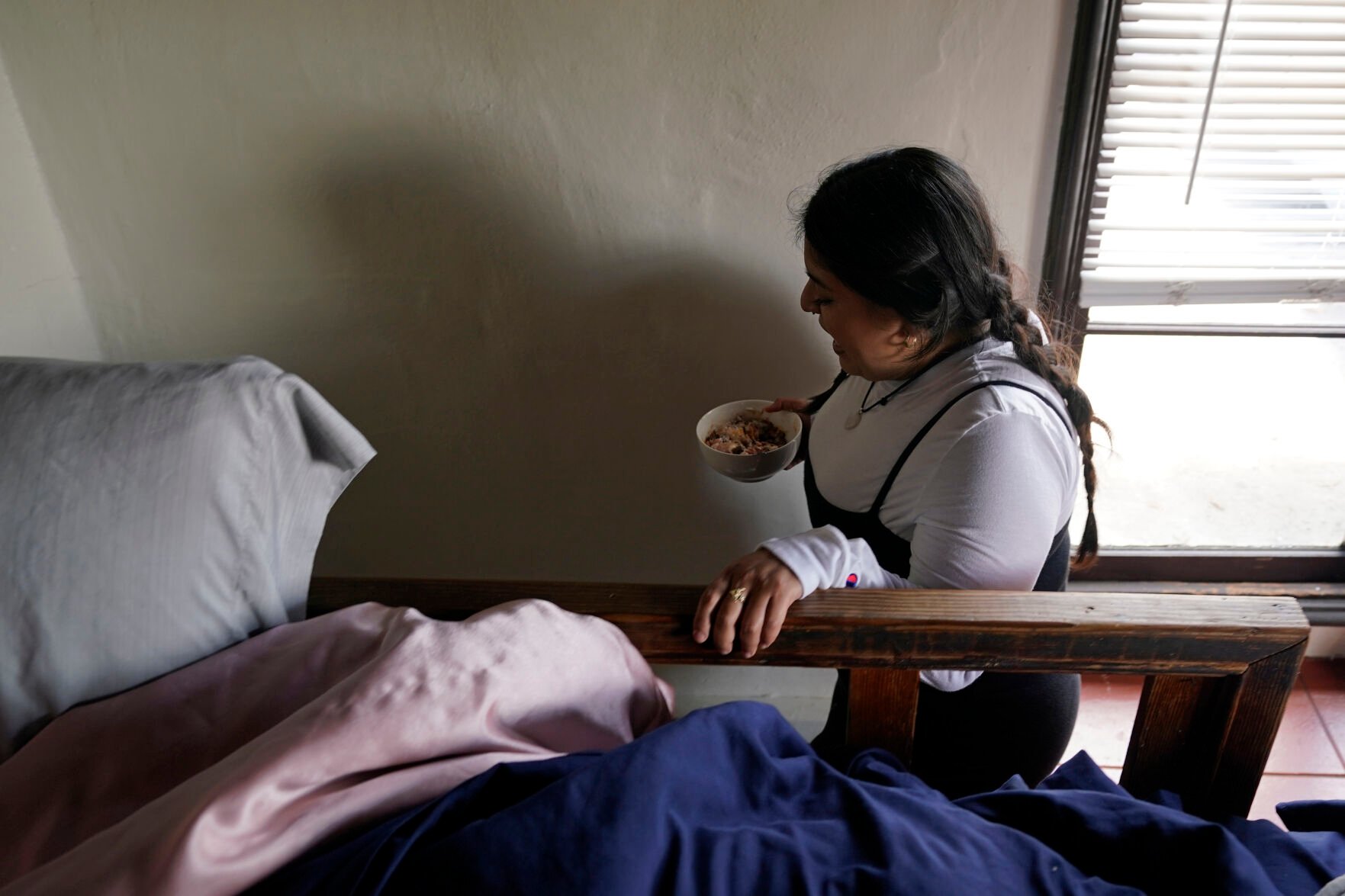 <p>University of California, Berkeley student Jennifer Lopez, makes her way down a tiny set of stairs from her bedroom loft of the apartment she shares with three others in Berkeley, Calif., Tuesday, March 29, 2022. </p>