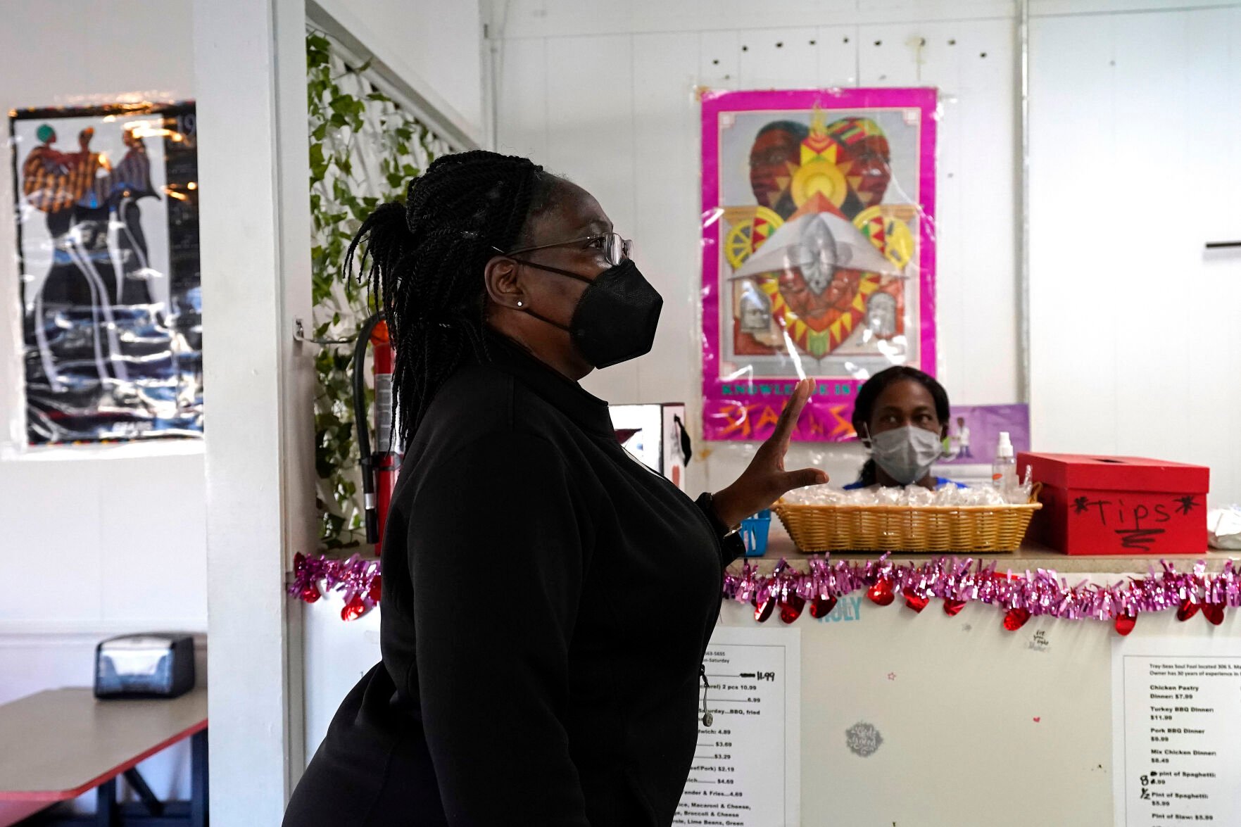 <p>Carolyn Suggs Bandy talks with owner Tracey Knight while picking up take-out food at Tray-Seas Soul Food Restaurant in Princeville, N.C., Monday, Feb. 28, 2022. Bandy proudly gushed about her birthplace, a town that stakes its claim as the oldest chartered by Black Americans nearly 140 years ago. </p>