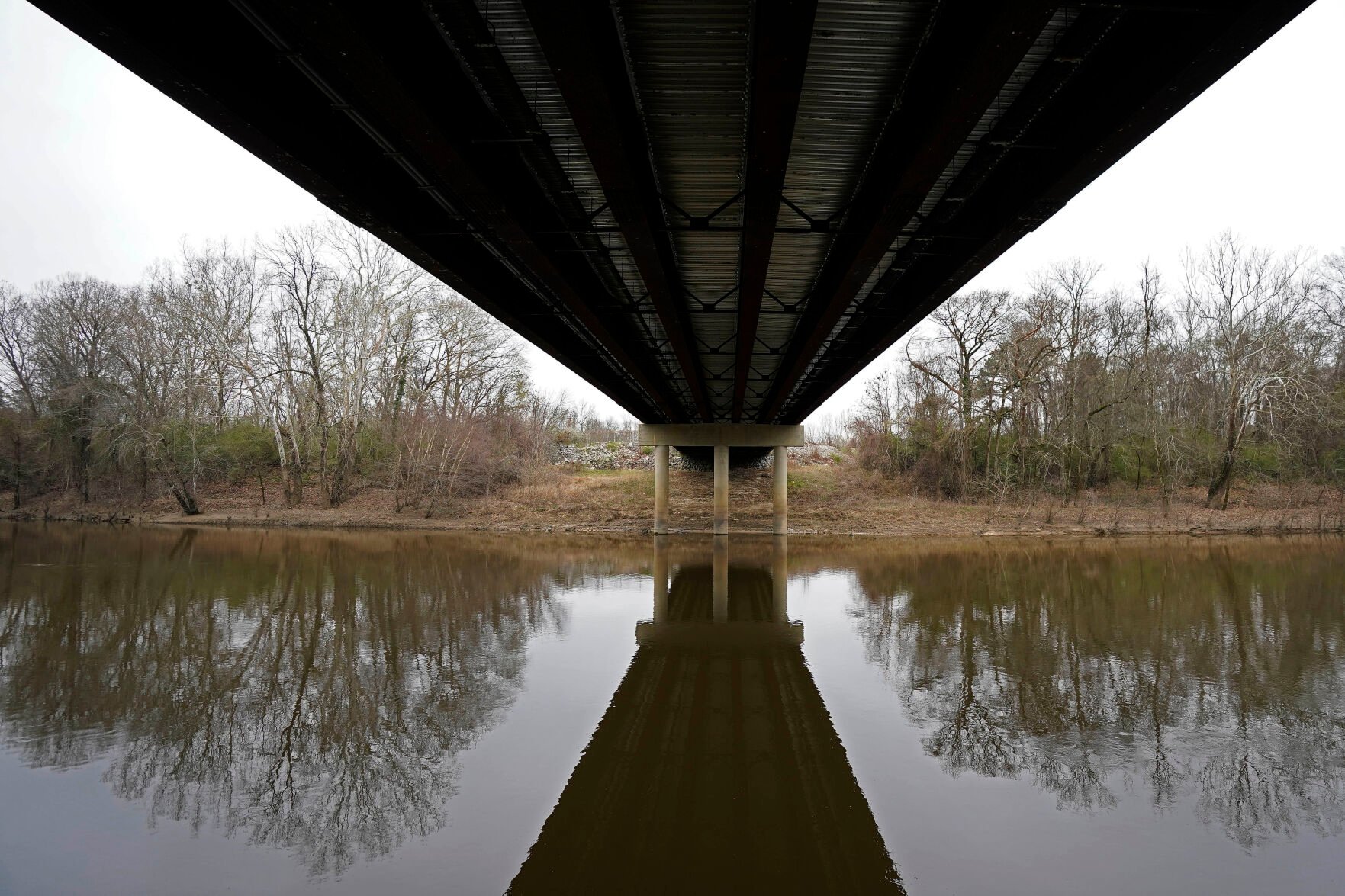 <p>The Tar River flows under the bridge connecting Tarboro and Princeville, N.C., Thursday, March 10, 2022. The river has flooded twice in recent history due to hurricanes, leaving permanent scars on the town of Princeville. </p>