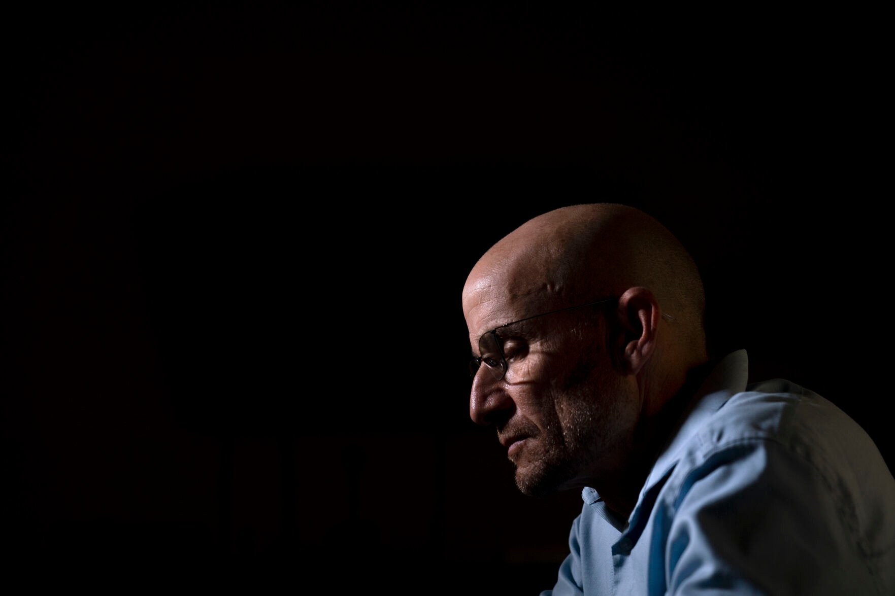 <p>Harry Bruell looks at photos of his daughter, Taya, saved in his smartphone while sitting for a photo in his office in Santa Barbara, Calif., Wednesday, March 9, 2022. Taya killed herself when she was 14. </p>