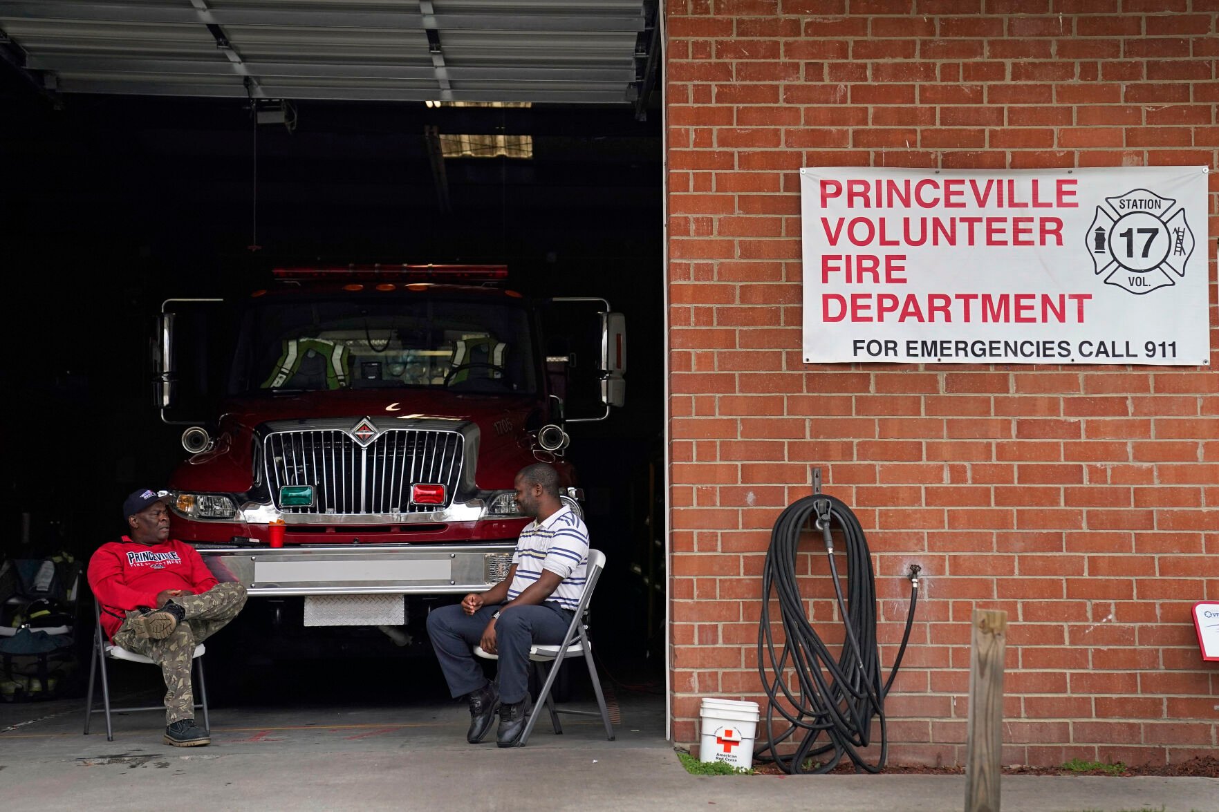 <p>Volunteer firefighters wait for their next call in Princeville, N.C., Thursday, March 17, 2022. The fire department was a lifeline for many Princeville residents during historic floods caused by hurricanes. </p>