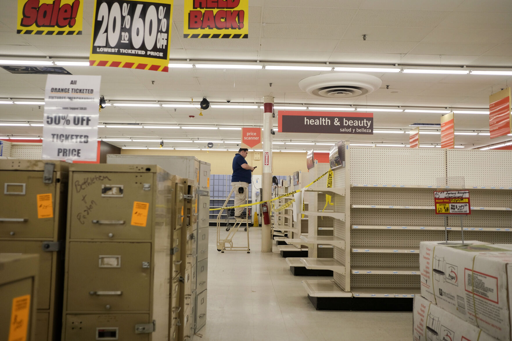 <p>While many shelves are empty, furniture and fixtures were still on sale April 4 at the Kmart in Avenel, N.J. The store will close for good on Saturday.</p>