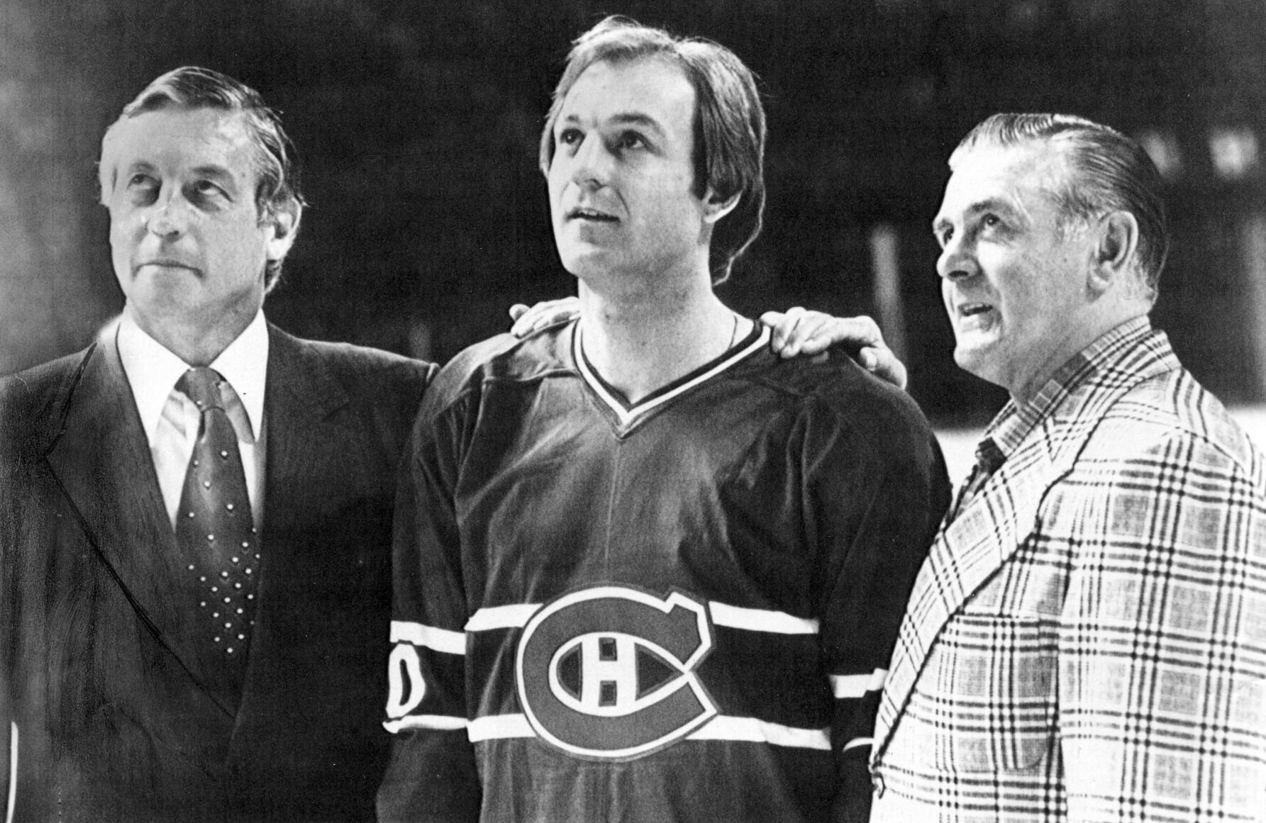 <p>FILE - Former Montreal Canadians' Jean Beliveau, left, and and Maurice Richard, right, flank Canadiens Guy Lafleur at the Forum in Montreal, April 12, 1979. Hockey Hall of Famer Guy Lafleur, who helped the Montreal Canadiens win five Stanley Cup titles in the 1970s, died Friday, April 22, 2022, at age 70. </p>