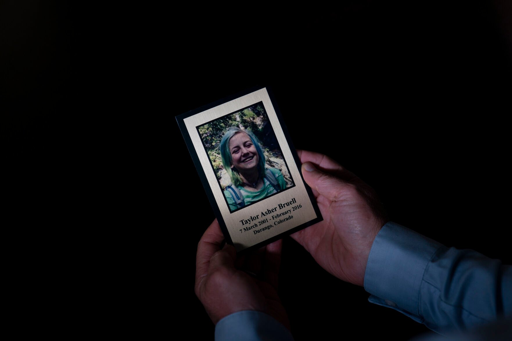 <p>Harry Bruell holds a framed photo of his daughter, Taya, while sitting for a photo in his office in Santa Barbara, Calif., Wednesday, March 9, 2022. Taya killed herself when she was 14. </p>