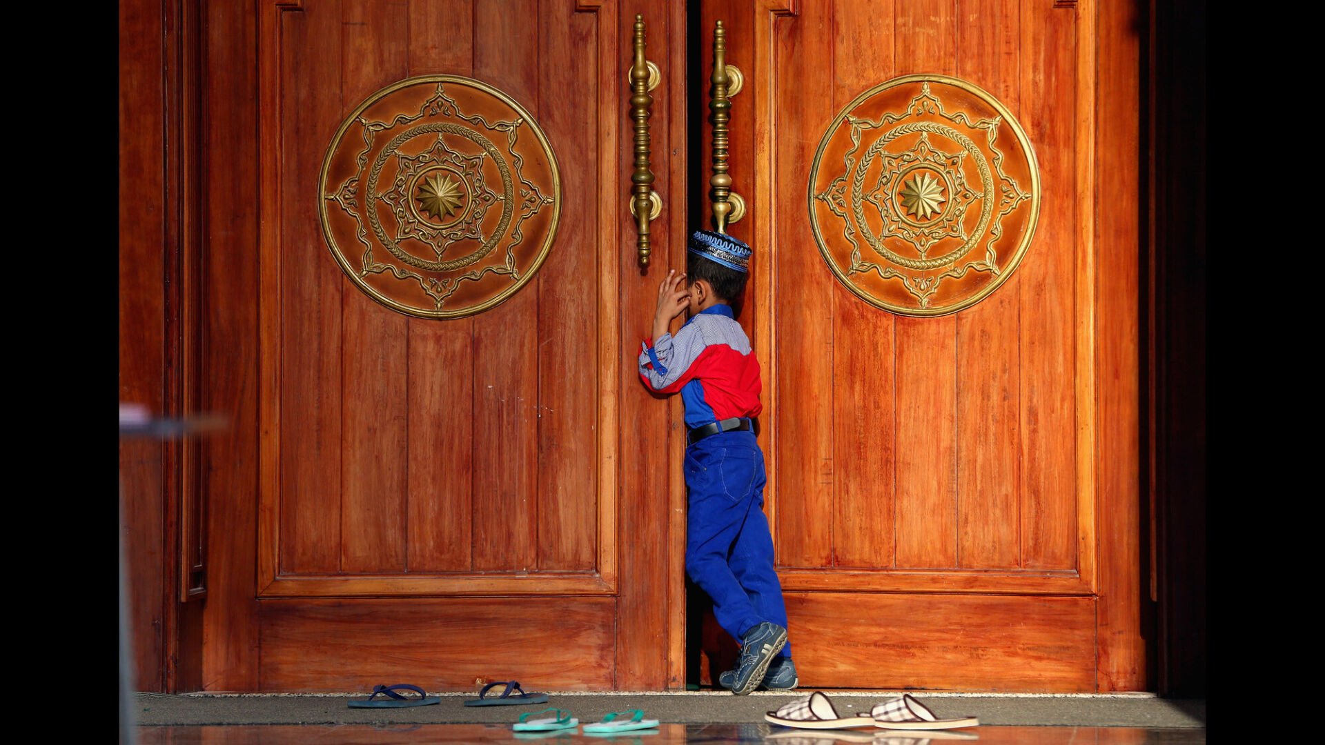 <p>A boy attends the early morning prayer at Al Noor Mosque in Sharjah, UAE.</p>