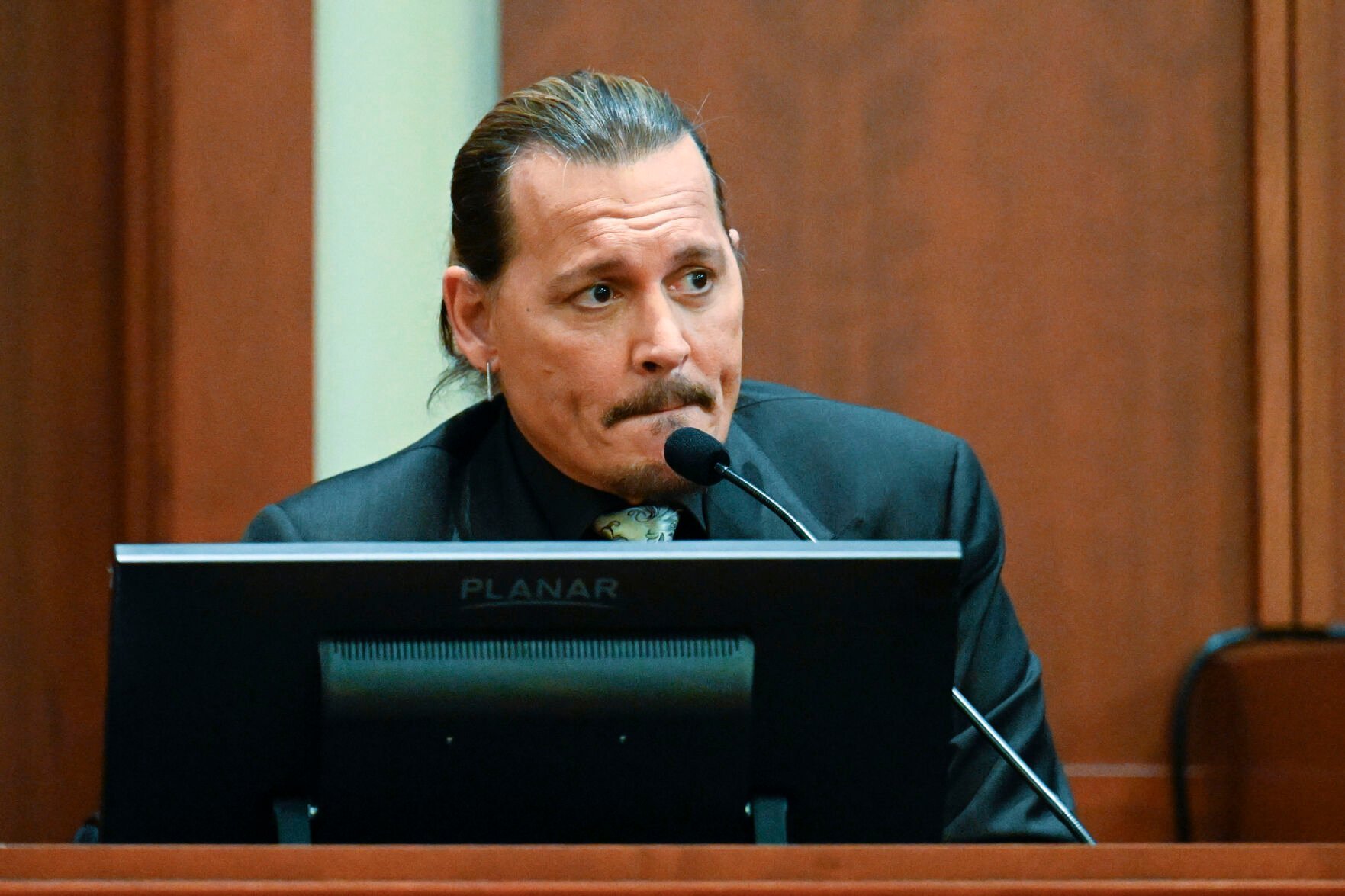 <p>Actor Johnny Depp testifies during a hearing at the Fairfax County Circuit Court in Fairfax, Va., Tuesday April 19, 2022. Depp sued his ex-wife Heard for libel in Fairfax County Circuit Court after she wrote an op-ed piece in The Washington Post in 2018 referring to herself as a "public figure representing domestic abuse."</p>