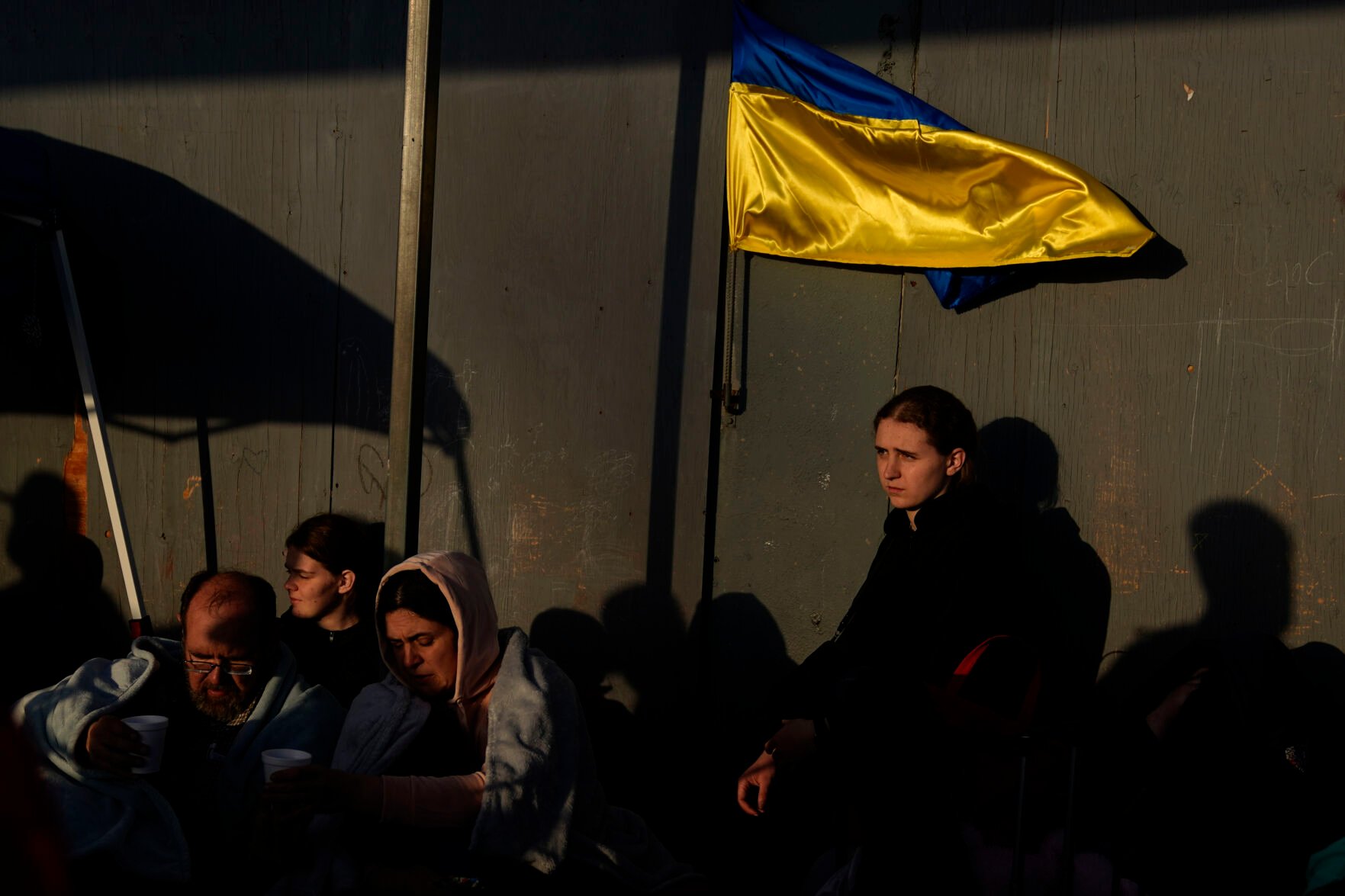 <p>Ukrainian refugees wait near the U.S. border Monday, April 4, 2022, in Tijuana, Mexico. About 200 to 300 Ukrainians were being admitted daily at the San Ysidro crossing this week, with hundreds more arriving in Tijuana, according to volunteers who manage the waiting list. There were 973 families or single adults waiting on Tuesday. (AP Photo/Gregory Bull)</p>