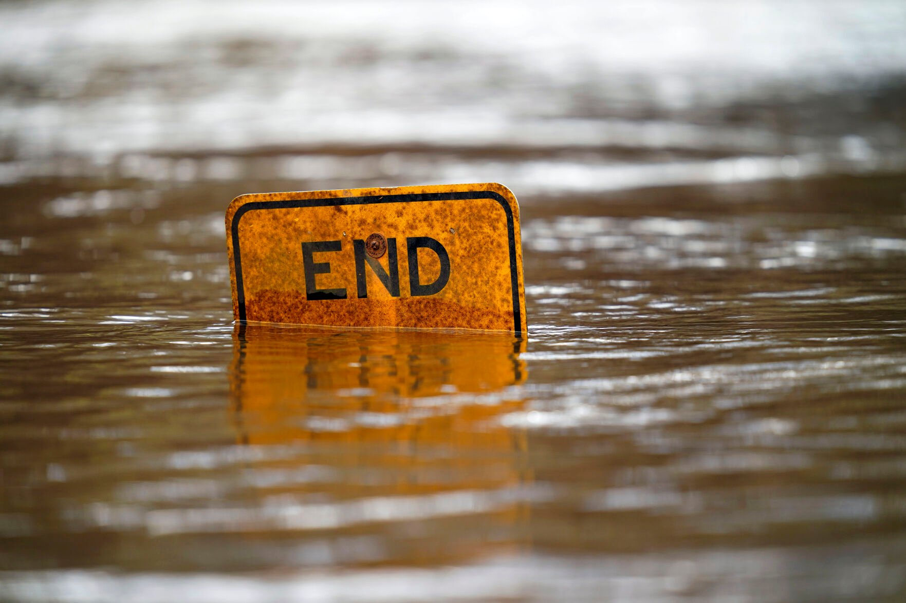 <p>A boat ramp sign is submerged in the Tar River as it rises following a heavy rain in Princeville, N.C., Thursday, March 17, 2022. The river continues to be a threat to the small community nestled in the flood plain of the Tar River. </p>