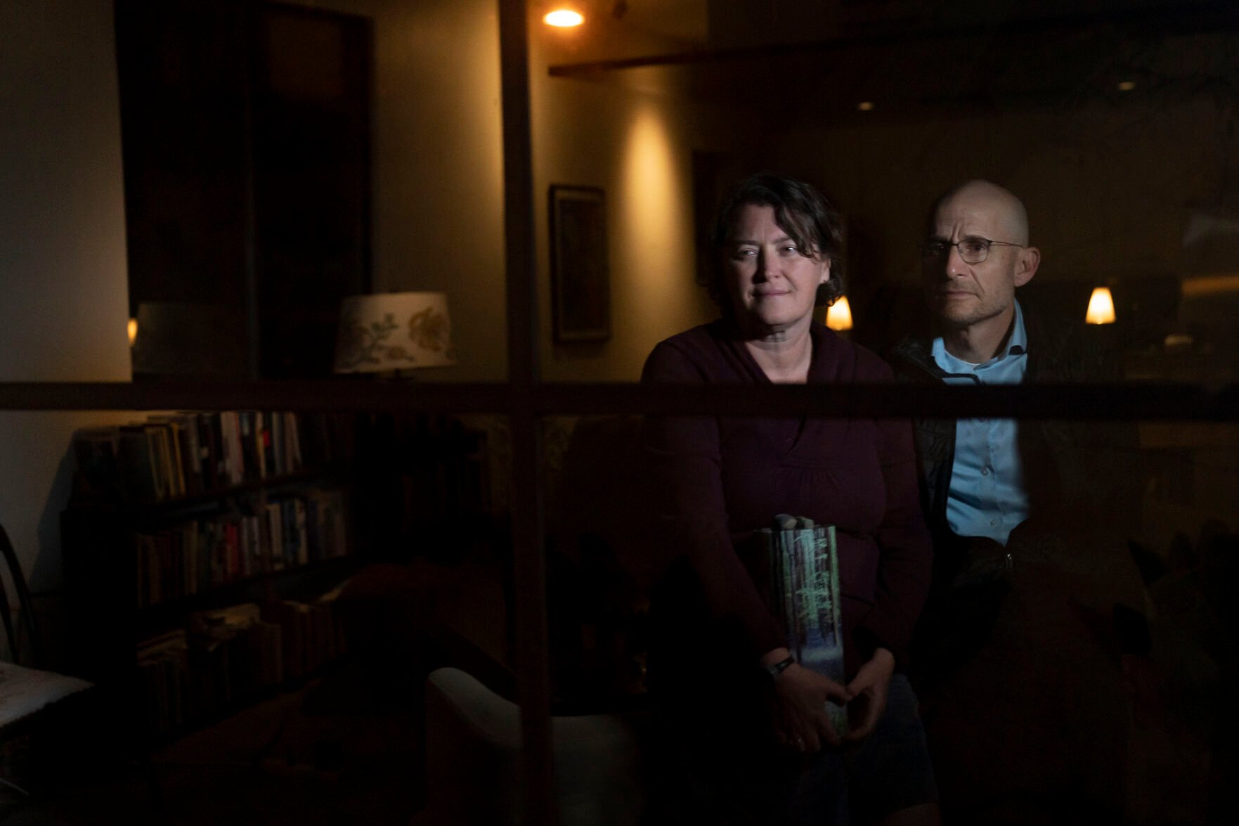 <p>Harry Bruell, right, and wife, Jenny, sit for a photo with an urn containing the ashes of their daughter, Taya, in Santa Barbara, Calif., Wednesday, March 9, 2022. </p>