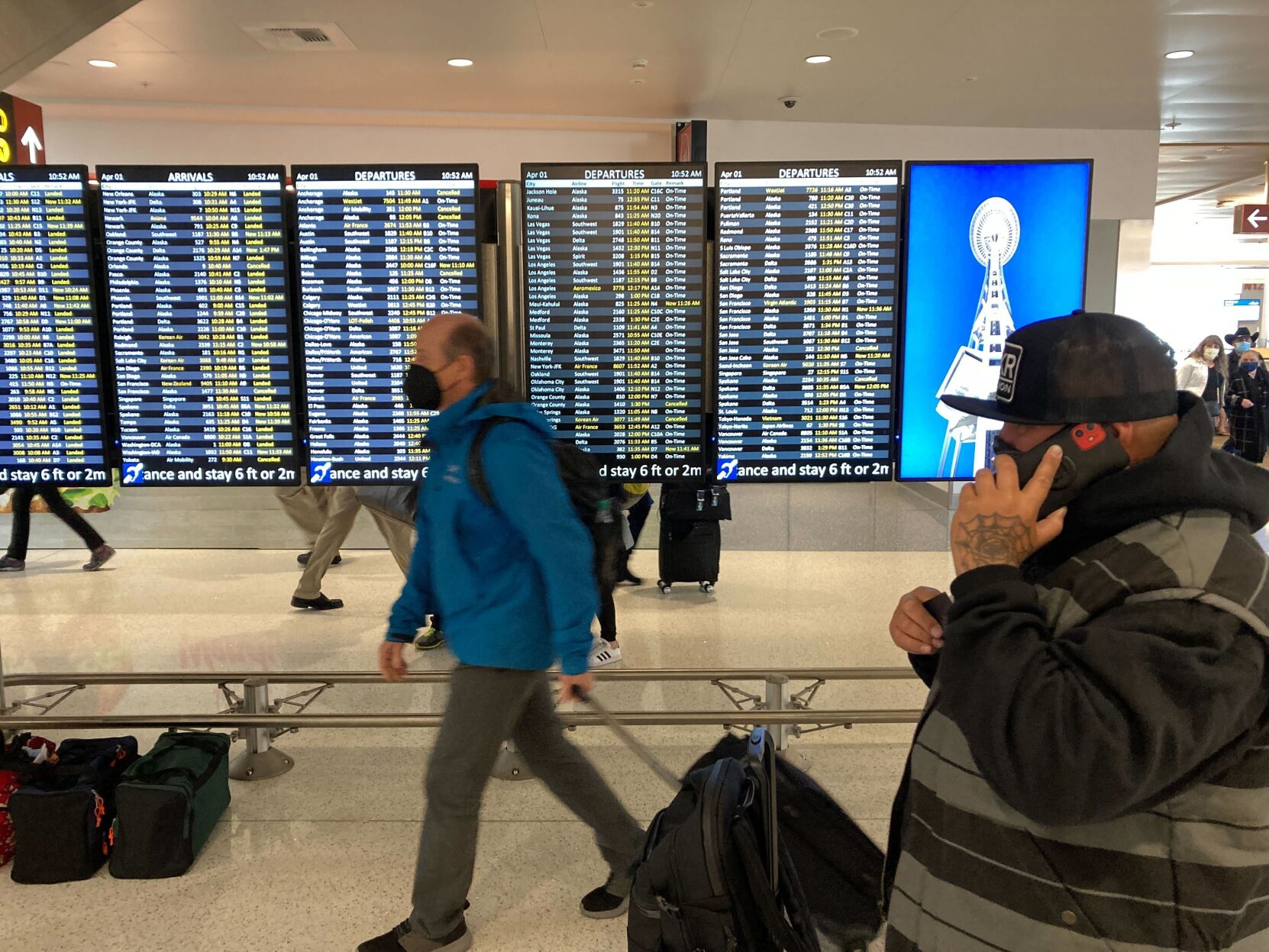 <p>Travelers walk through Seattle-Tacoma International Airport on Friday, April 1, 2022 in Seattle.</p>