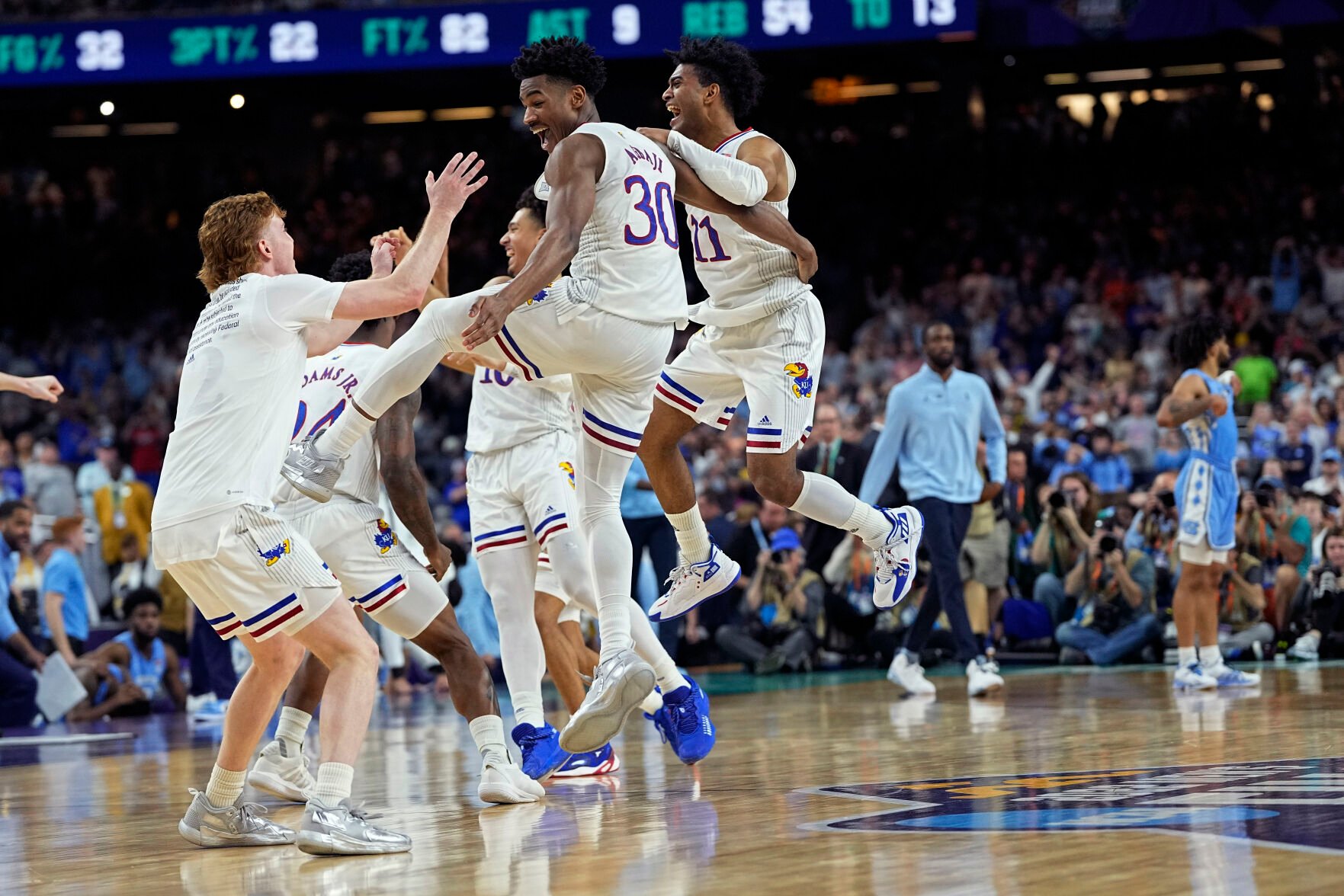 <p>Kansas guard Ochai Agbaji celebrates with teammates after their win against North Carolina during a college basketball game in the finals of the Men's Final Four NCAA tournament, Monday, April 4, 2022, in New Orleans. (AP Photo/David J. Phillip)</p>