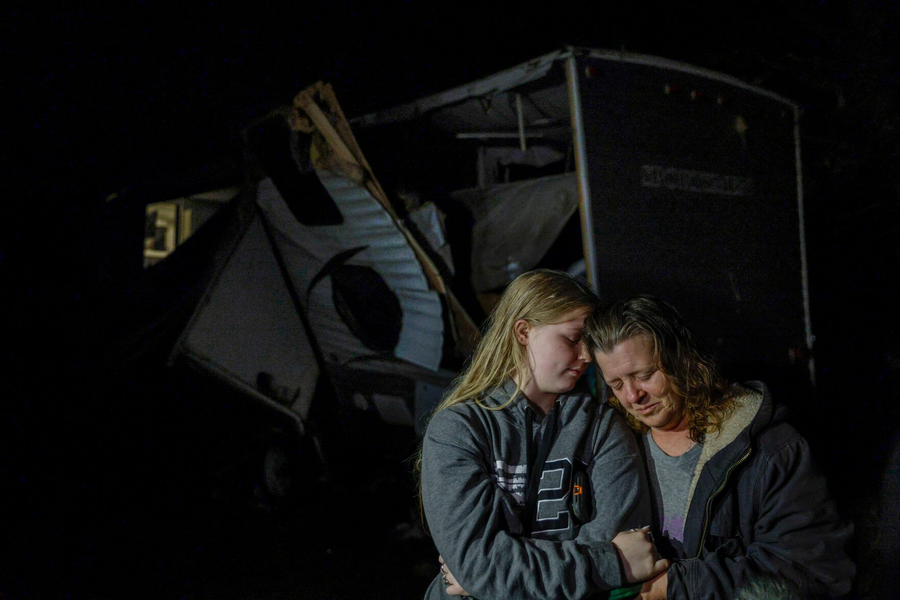 <p>Brittaney Deaton, 17, left, comforts her mother Amber Zeleny, 53, while speaking with reporters after a severe storm passed in Johnson County near Burleson, Texas, Tuesday, April 5, 2022. The latest round of storms to pound the South prompted a flurry of tornado warnings at the start of what forecasters said could be two days of violent weather in the region. More than 55,000 homes and businesses were without power Tuesday morning from eastern Texas to southern Mississippi after storms.</p>