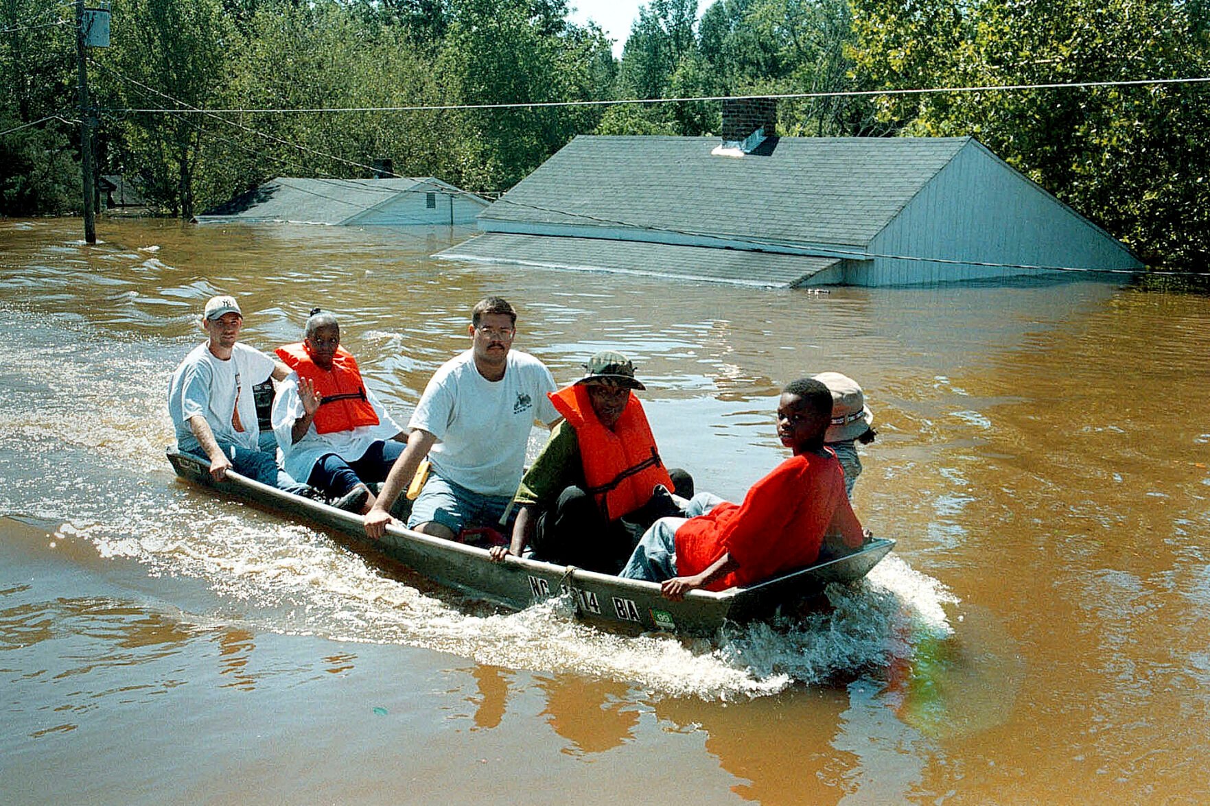 <p>FILE - A boat carrying a group of Princeville, N.C., residents travels down Main Street after floodwaters from the Tar River completely flooded the town on Sept. 17, 1999, in the aftermath of Hurricane Floyd. </p>