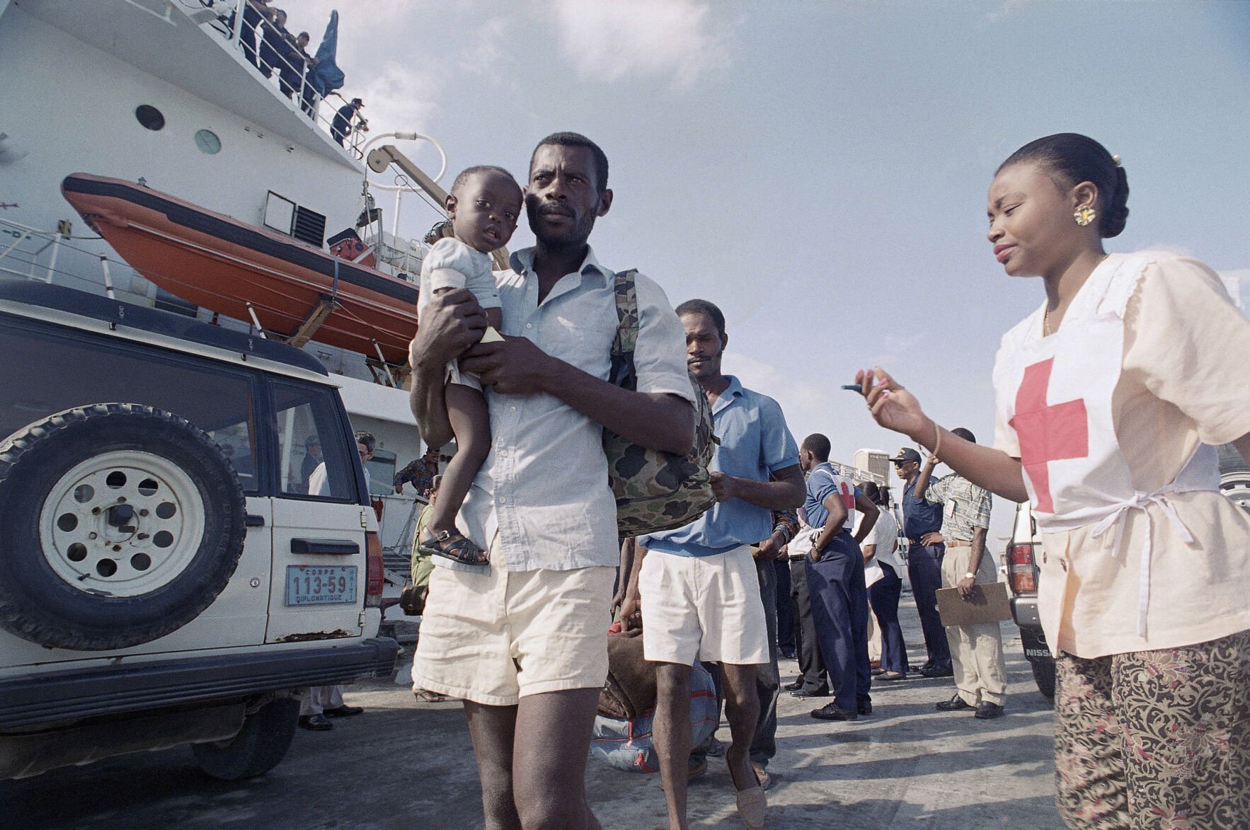 <p>Part of a group of 145 repatriated Haitian boat people make their way to a processing center upon their return to Port-au-Prince, Nov. 24, 1992. The group was intercepted by the U.S. Coast Guard after six day at sea. (AP Photo/Daniel Morel)</p>