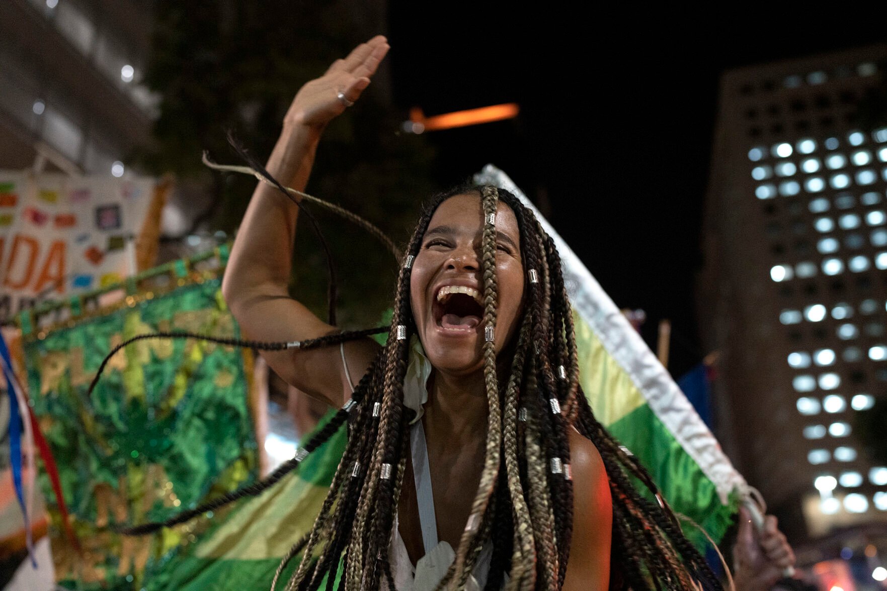 <p>A reveller of a street party known as blocos, dances during a protest against restrictions by city officials in Rio de Janeiro, Brazil, Wednesday, April 13, 2022. City Hall has banned the street parties during Carnival celebrations, which were delayed by almost two months due to the pandemic. (AP Photo/Silvia Izquierdo)</p>