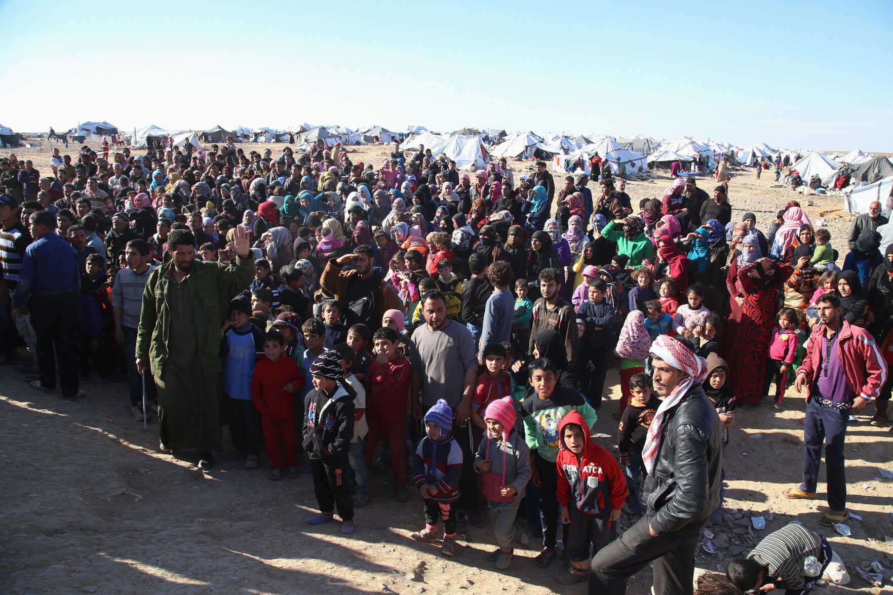 <p>FILE - In this Jan. 14, 2016 file photo, Syrian refugees inside the border wait to be approved to get into Jordan, in the Hadalat reception area, near the northeastern Jordanian border with Syria, and Iraq, near the town of Ruwaished, Jordan. (AP Photo/Raad Adayleh, File)</p>