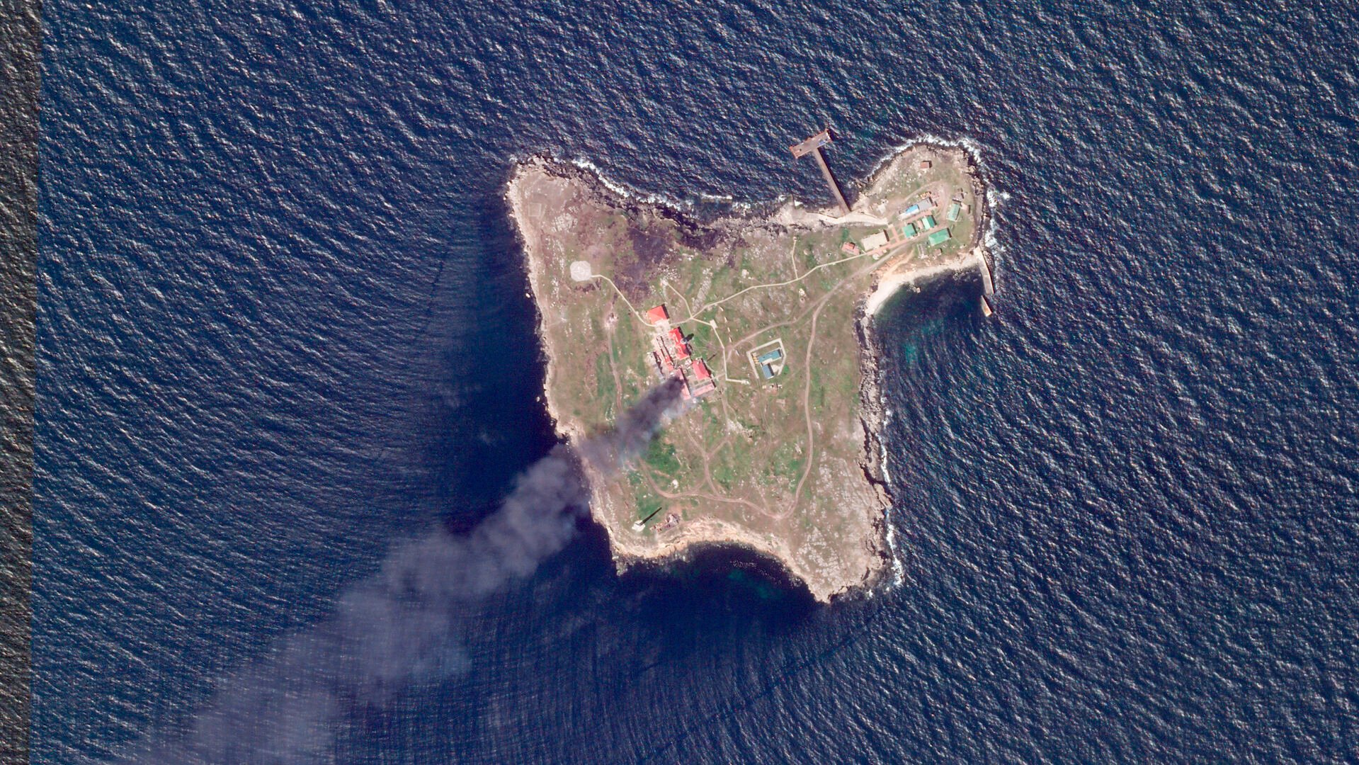 <p>This satellite image taken by Planet Labs PBC shows thick black smoke rising after a suspected Ukrainian drone strike on Russian positions on Snake Island, Ukraine, in the Black Sea Friday, May 6, 2022. (Planet Labs PBC via AP)</p>