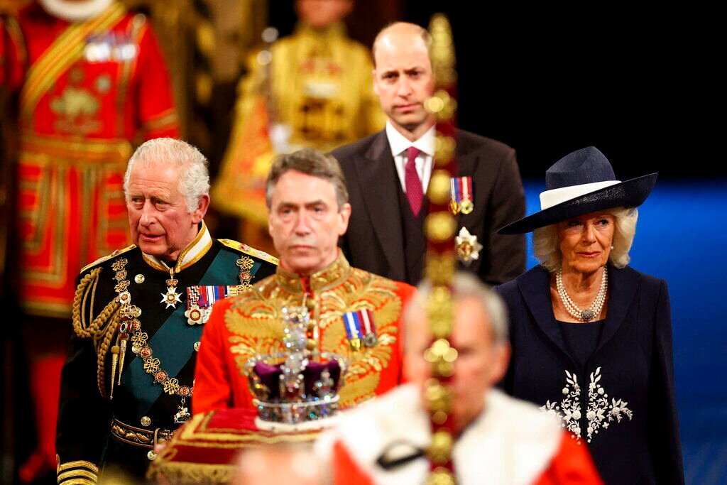 <p>Britain's Prince Charles, Camilla, Duchess of Cornwall, and Britain's Prince William proceed behind the Imperial State Crown through the Royal Gallery for the State Opening of Parliament at the Palace of Westminster in London, Tuesday, May 10, 2022. </p>