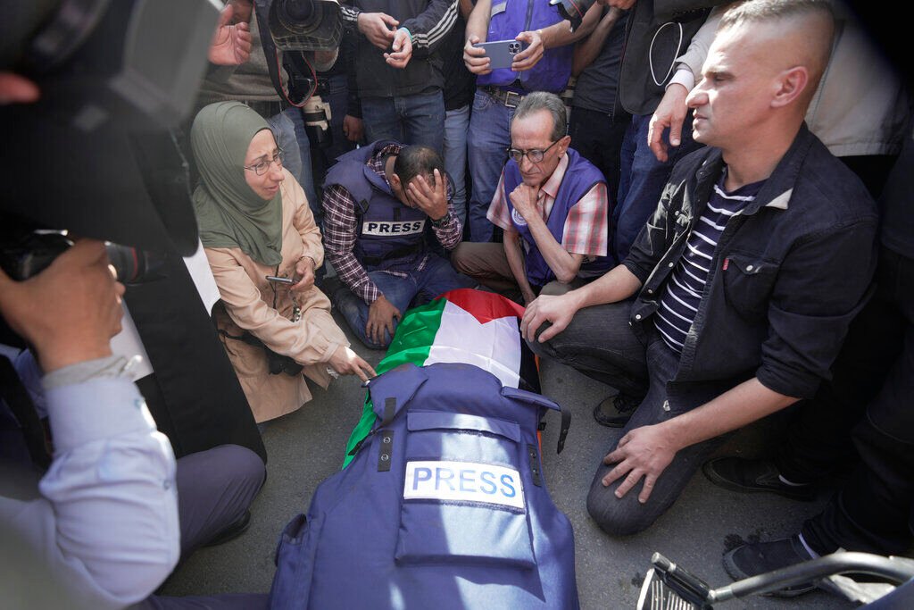 <p>Journalists surround the body of Shireen Abu Akleh, a journalist for Al Jazeera network, in the West Bank town of Jenin, Wednesday, May 11, 2022. </p>