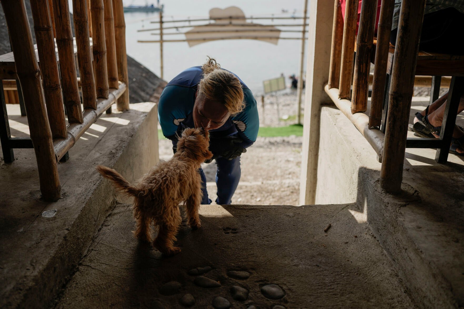 <p>Queen Pangke Tabora kisses her dog "Choknut" before teaching freediving and mermaiding classes at the Ocean Camp in Mabini, Batangas province, Philippines on Saturday, May 21, 2022. </p>