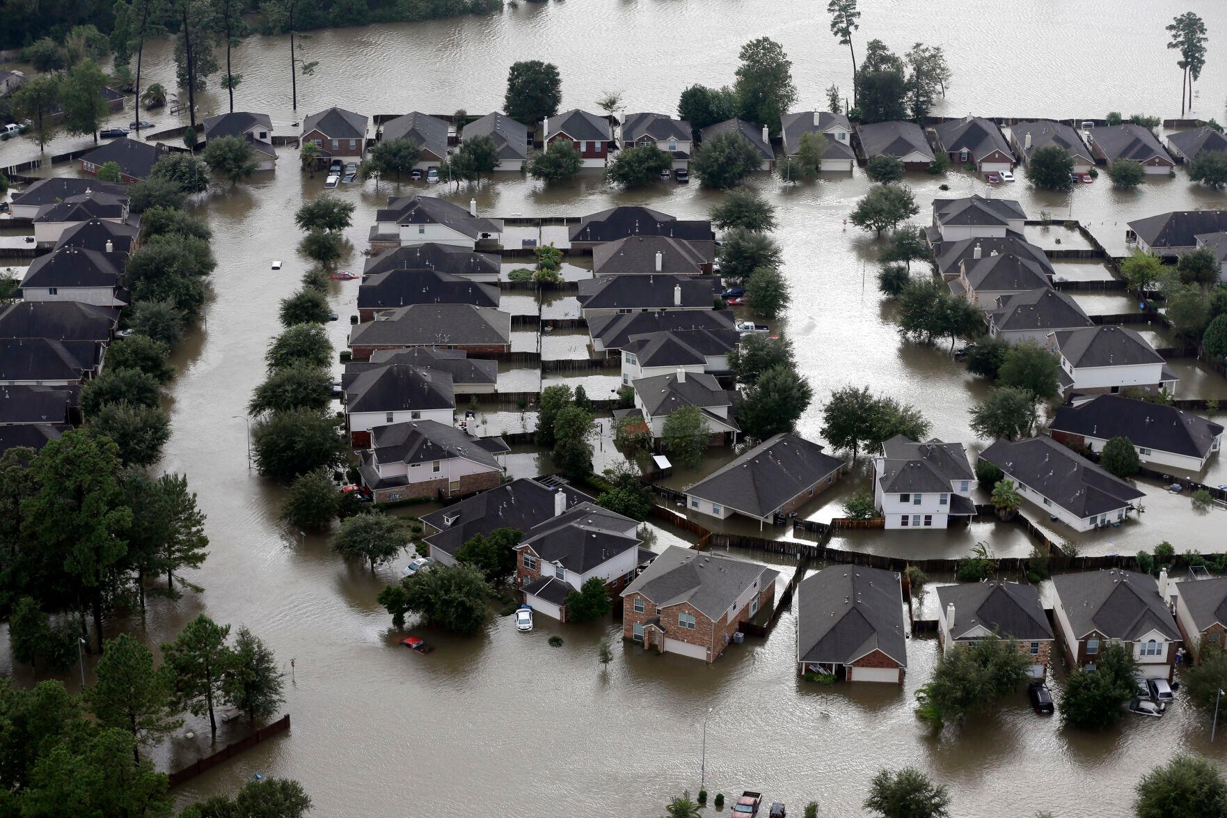 <p>Homes are surrounded by floodwaters from Hurricane Harvey in Spring, Texas, on Aug. 29, 2017.</p>