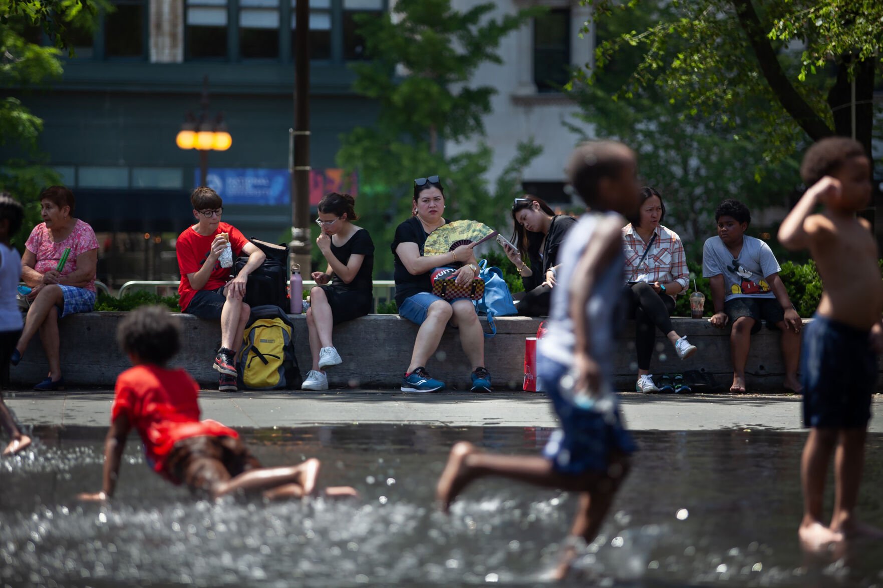 <p>Children play outside in downtown Chicago on Tuesday.</p>