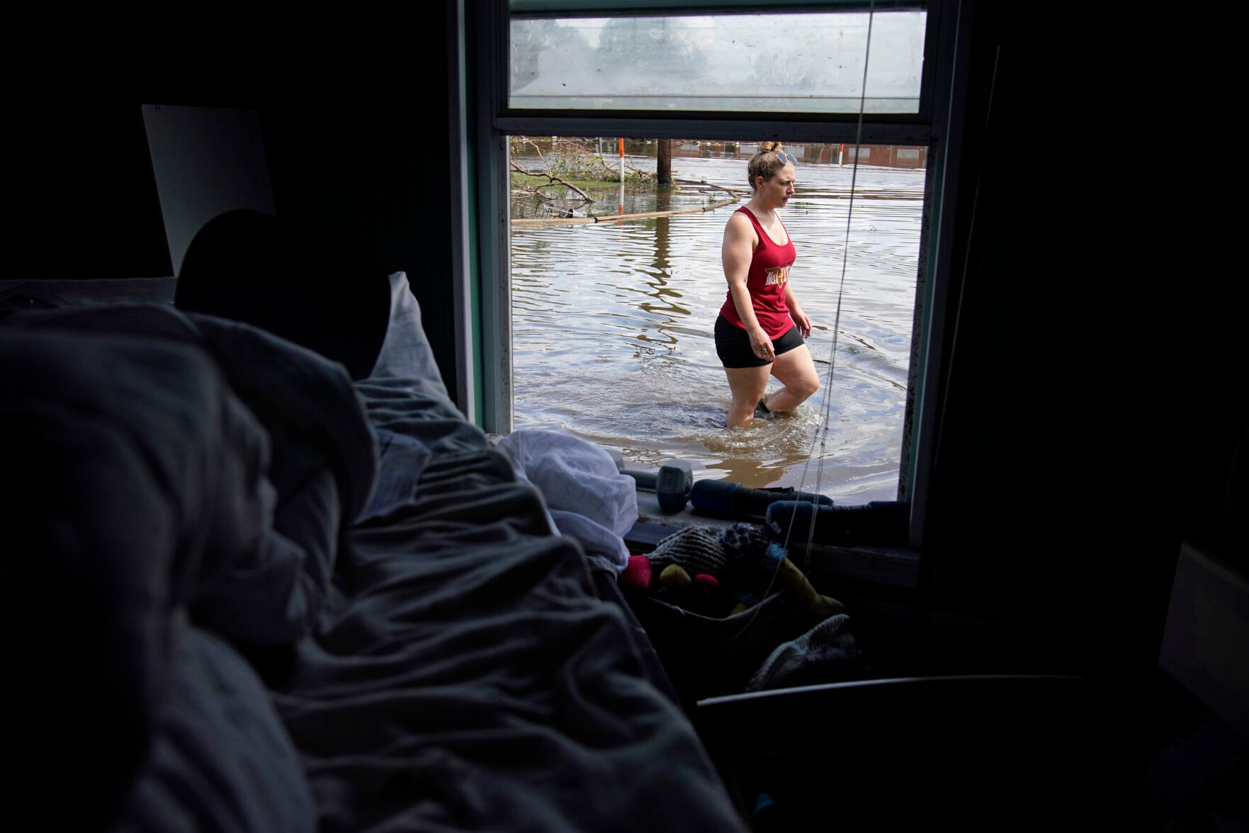 <p>Emily Francois walks through floodwater beside her flood-damaged home in the aftermath of Hurricane Ida on Sept. 1, 2021, in Jean Lafitte, La.</p>