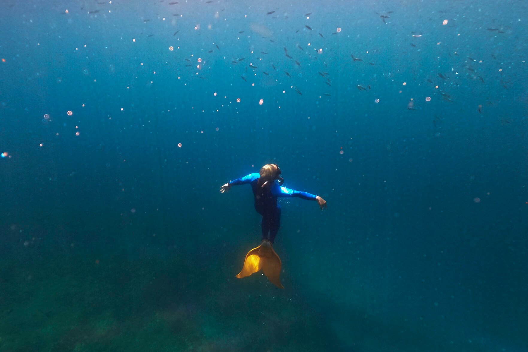 <p>Queen Pangke Tabora swims in her monofin as she demonstrates techniques to her mermaiding class in Mabini, Batangas province, Philippines on Saturday, May 21, 2022. The former insurance company worker described the experience of gliding under water, half-human and half-fish, as “meditation in motion.” </p>