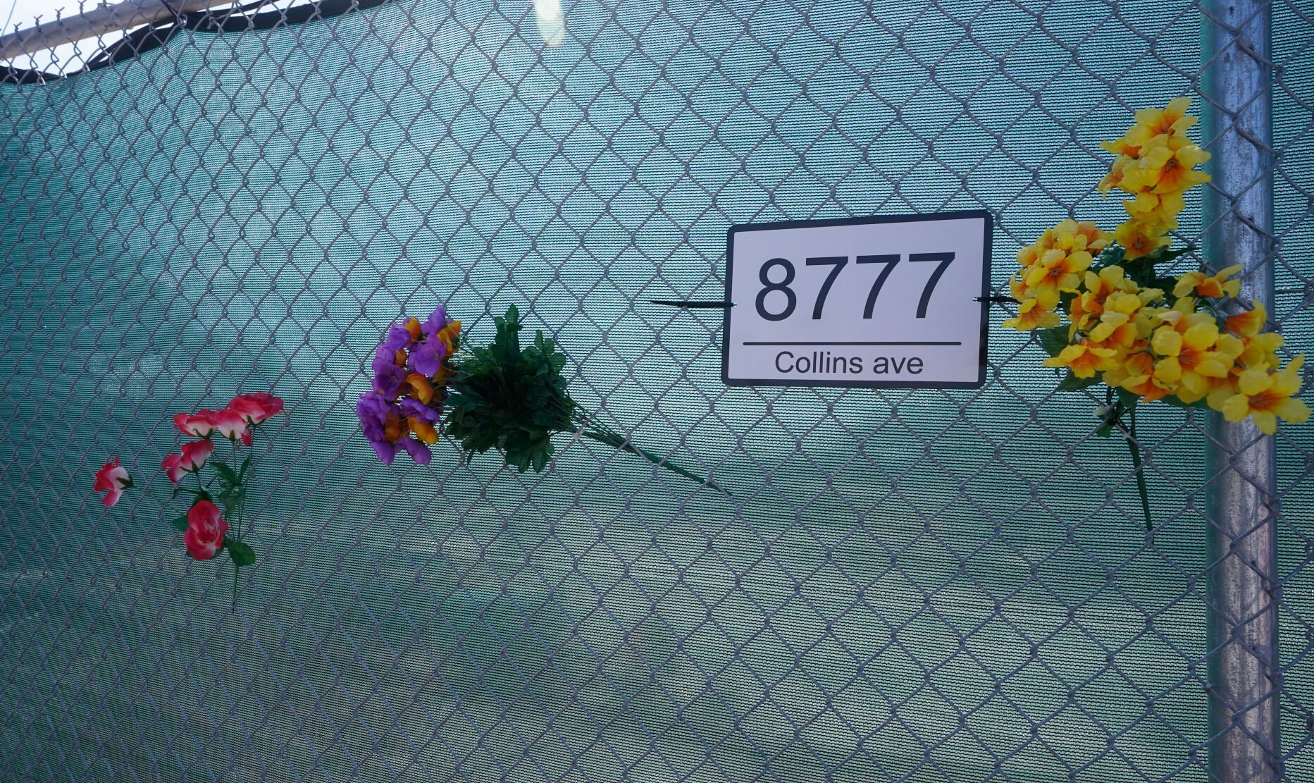 <p>Artificial flowers are shown on a fence on June 21, 2022, surrounding the site where Champlain Towers South collapsed, killing 98 people last year in Surfside, Fla. Friday marks the one-year anniversary of the oceanfront condo collapse.</p>