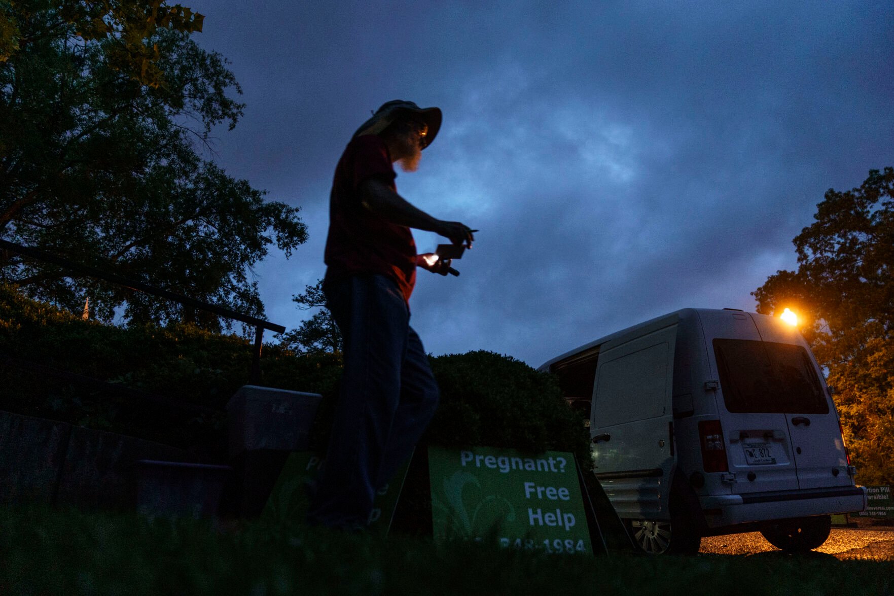 <p>Chris, a sidewalk counselor with the anti-abortion group, A Moment of Hope, who only gave his first name, arrives before sunrise to set up for the day outside the Planned Parenthood clinic where patients will be arriving for abortion appointments Friday, May 27, 2022, in Columbia, S.C. </p>