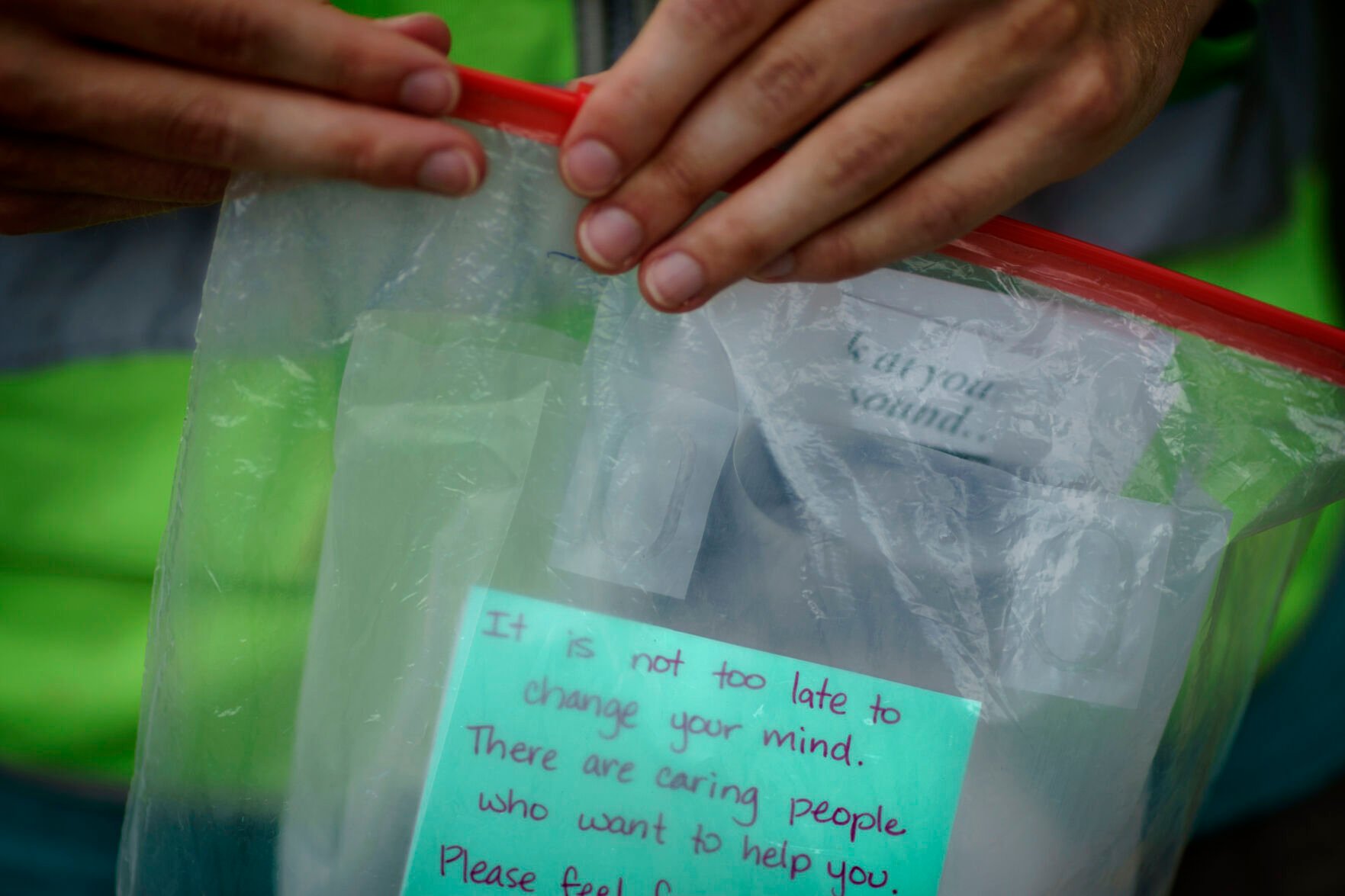 <p>A member of the anti-abortion group, A Moment of Hope, holds a gift bag they try to hand out to patients arriving for abortion appointments at a Planned Parenthood clinic, Friday, May 27, 2022, in Columbia, S.C. </p>