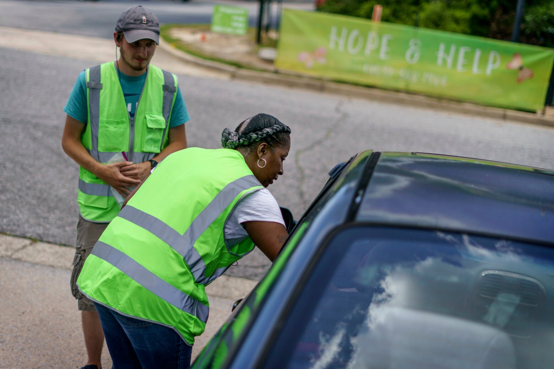 <p>Shonda Johnson, a volunteer for the anti-abortion group, A Moment of Hope, comforts a woman who leaves Planned Parenthood after going through with an abortion, Friday, May 27, 2022, in Columbia, S.C. </p>