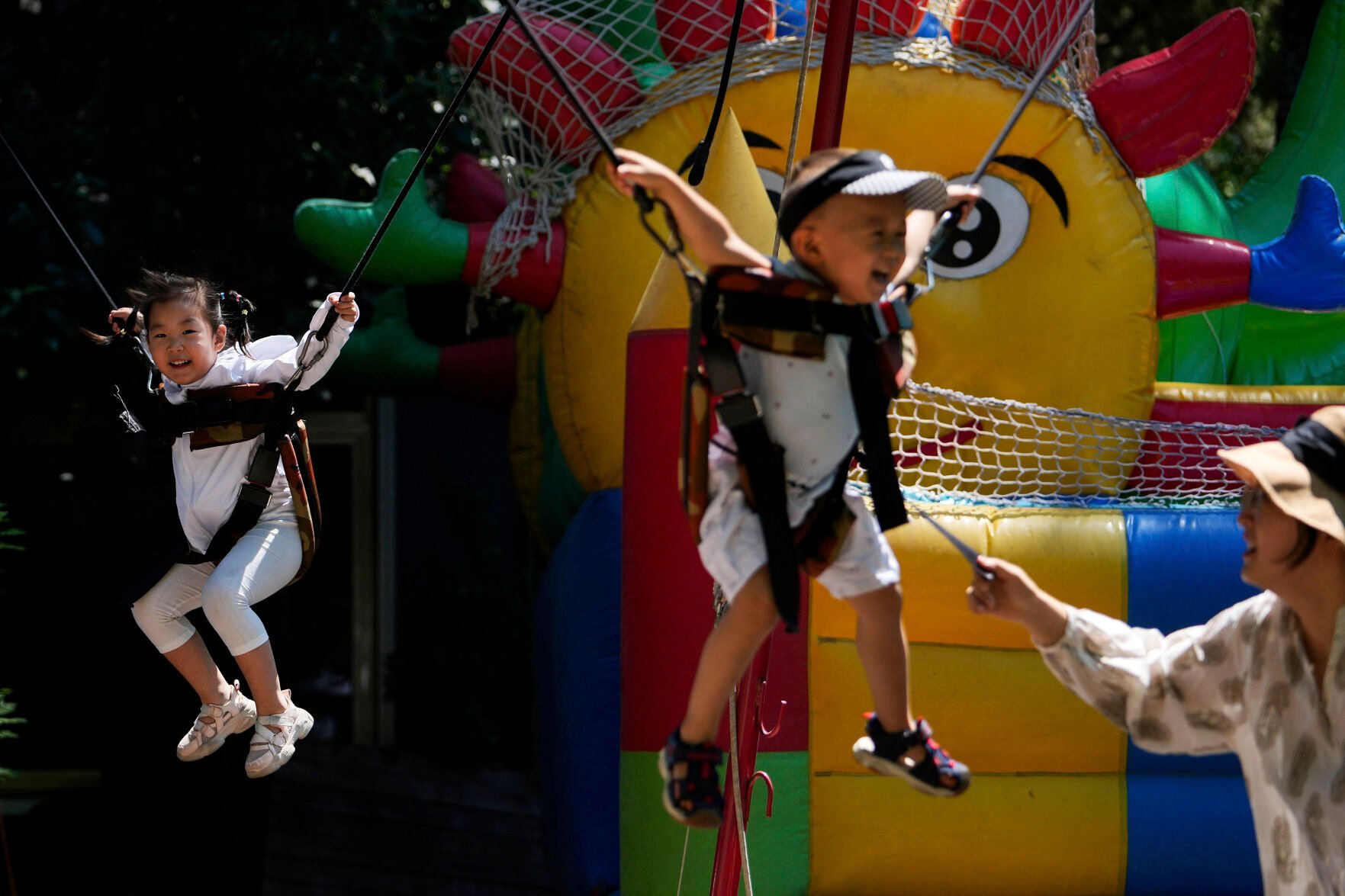 <p>Children play at an amusement park on International Children's Day in Beijing, Wednesday, June 1, 2022. Shopping malls, retail shops and parks reopened in the capital city after pandemic measure lockdown were lifted. (AP Photo/Andy Wong)</p>