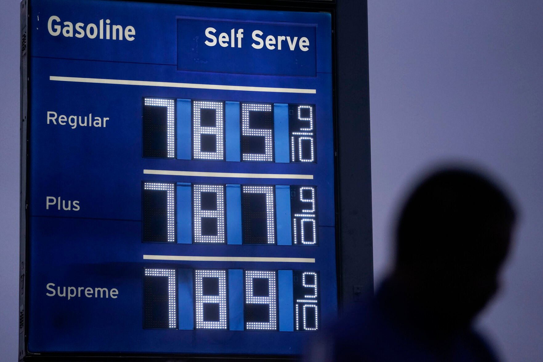 <p>FILE - High gas prices are shown as a pedestrian waits to cross the street in Los Angeles, June 16, 2022. President Joe Biden on June 22 will call on Congress to suspend the federal gasoline and diesel taxes for three months. </p>