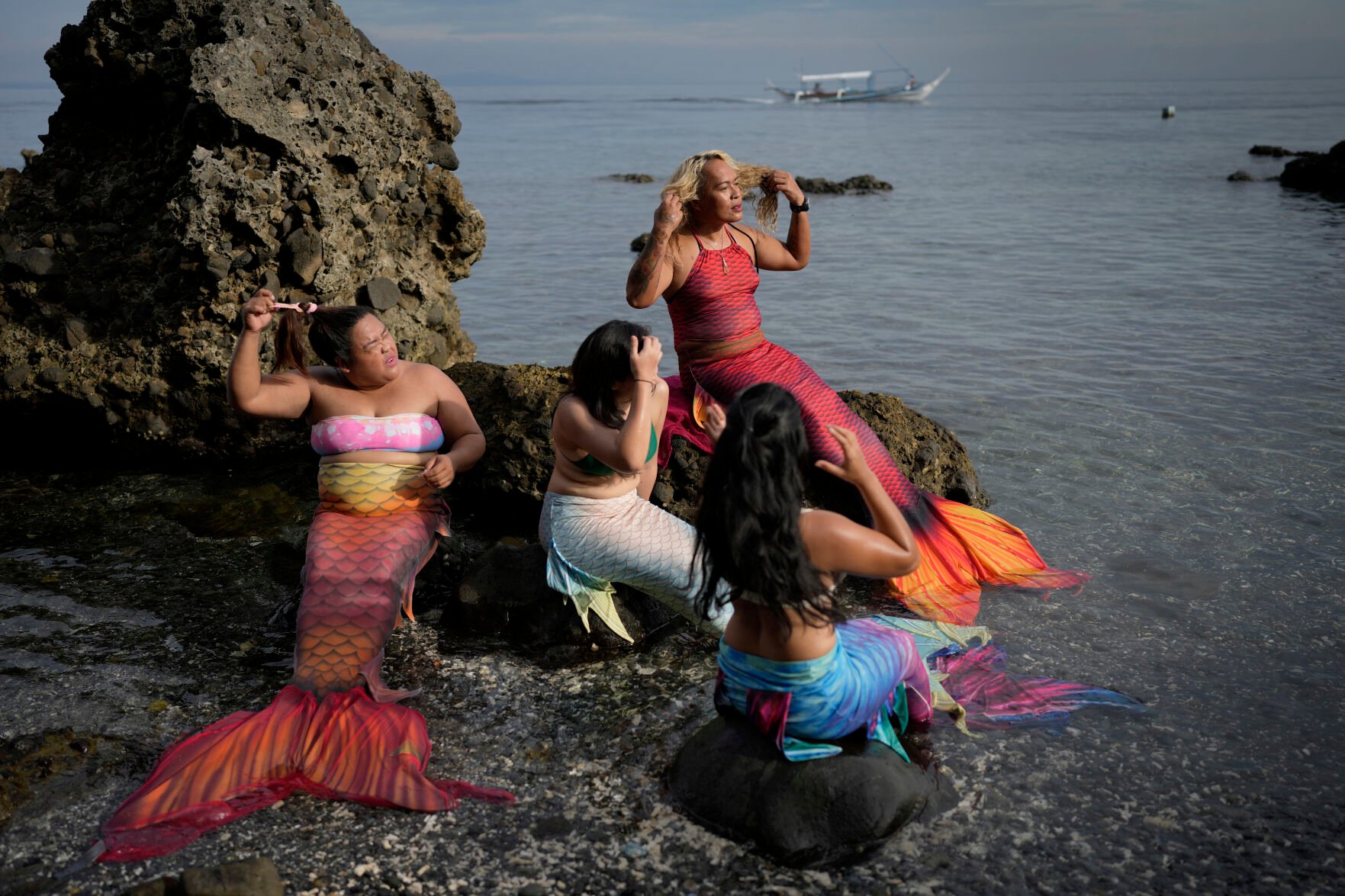 <p>Queen Pangke Tabora, right, and her students prepare for a mermaiding class at the Ocean Camp in Mabini, Batangas province, Philippines on Sunday, May 22, 2022. </p>