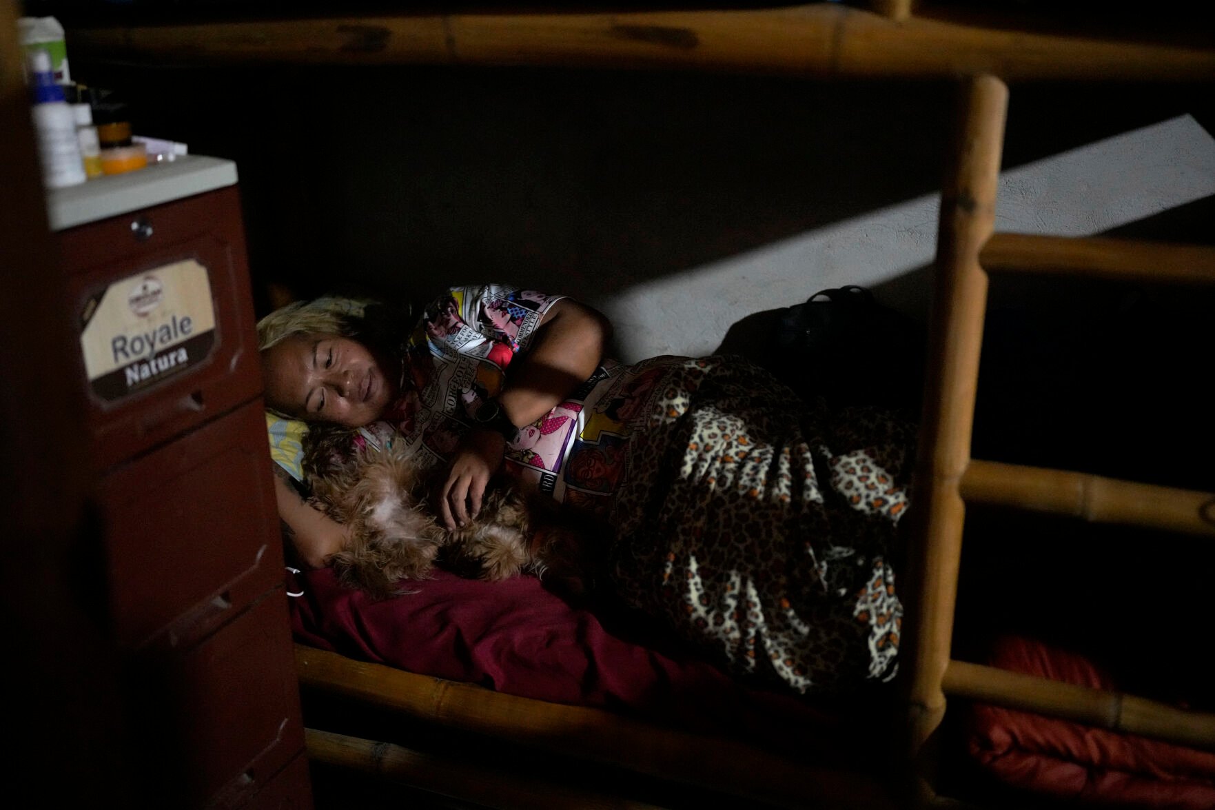 <p>Queen Pangke Tabora lies in bed with her dog "Choknut" inside their room at the Ocean Camp where she conducts freediving and mermaiding classes in Mabini, Batangas province, Philippines on Saturday, May 21, 2022. </p>