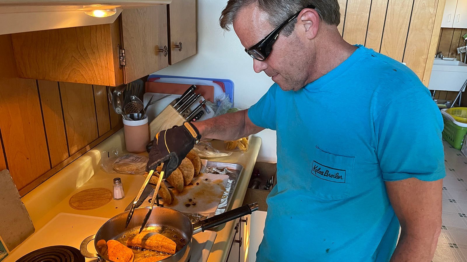 <p><span>John "Wedge" Wardlaw eats fried tacos June 14 in his protective gear.</span></p>