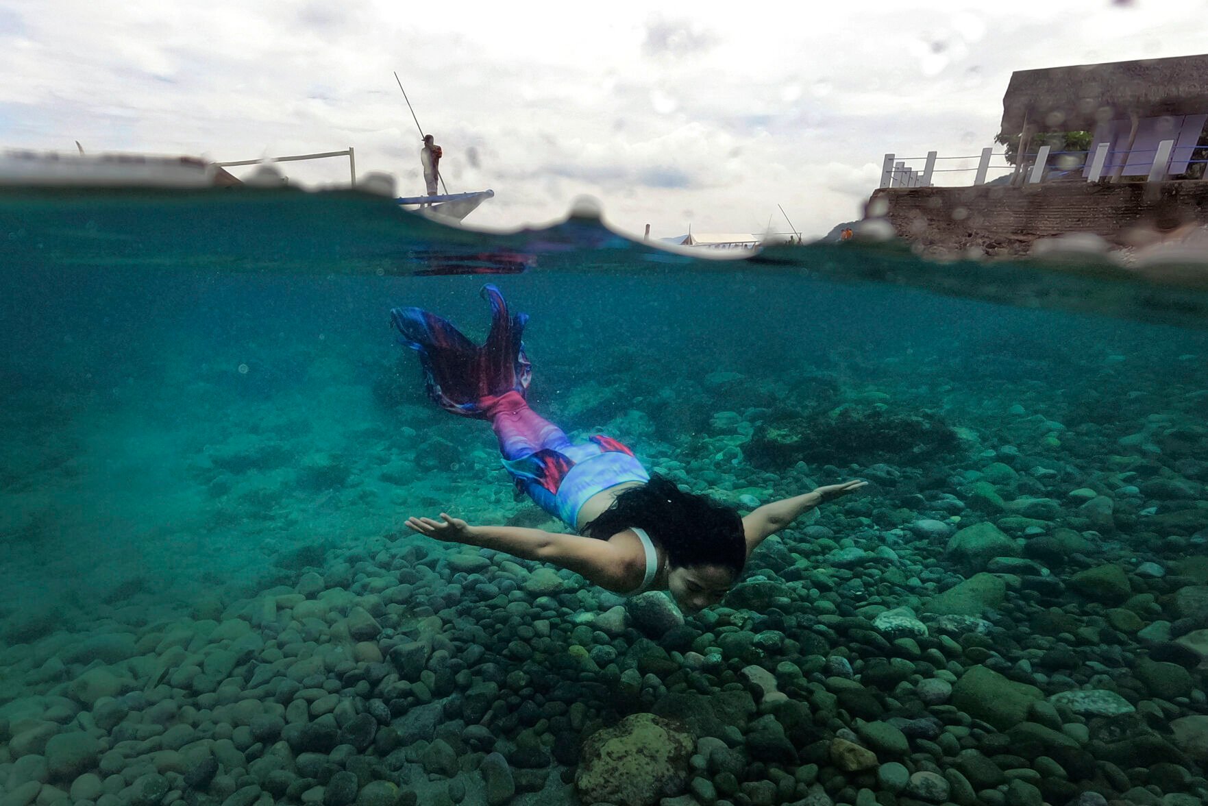 <p>Filipina Jennica Secuya swims in her mermaid suit during a mermaiding class in Mabini, Batangas province, Philippines on Sunday, May 22, 2022. </p>