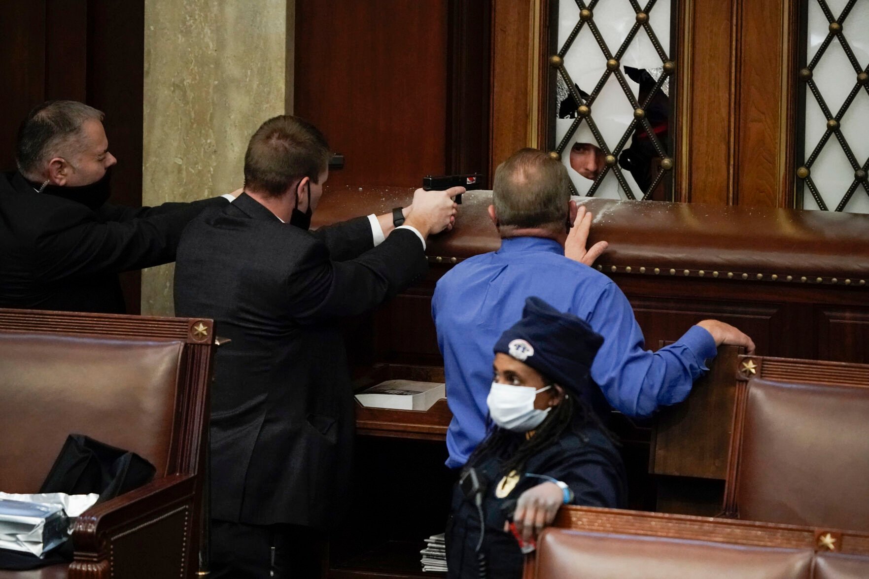 <p>FILE - Police with guns drawn watch as rioters try to break into the House Chamber at the U.S. Capitol on Jan. 6, 2021, in Washington. </p>